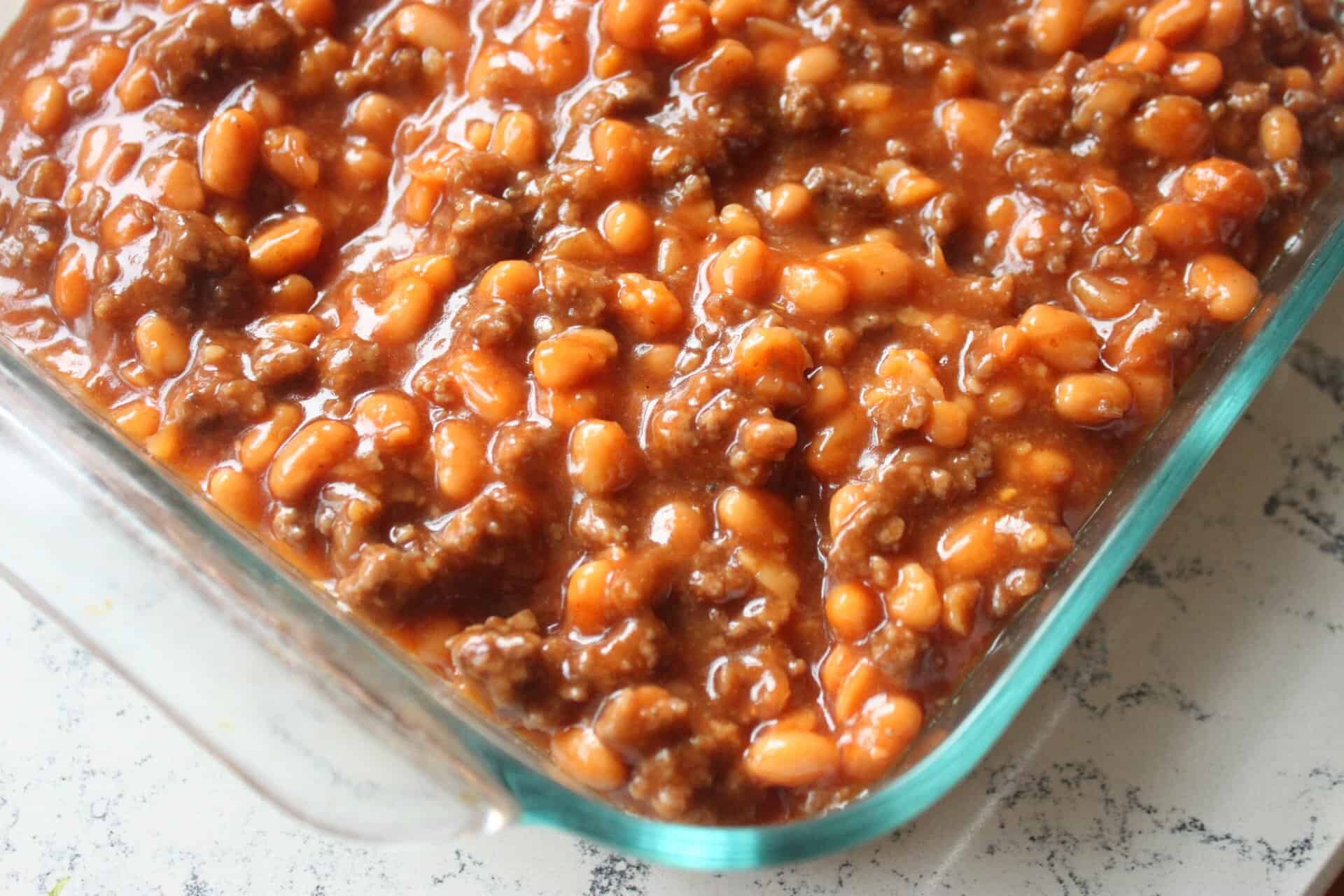 Hero shot of 30-minute baked beans in a glass dish.