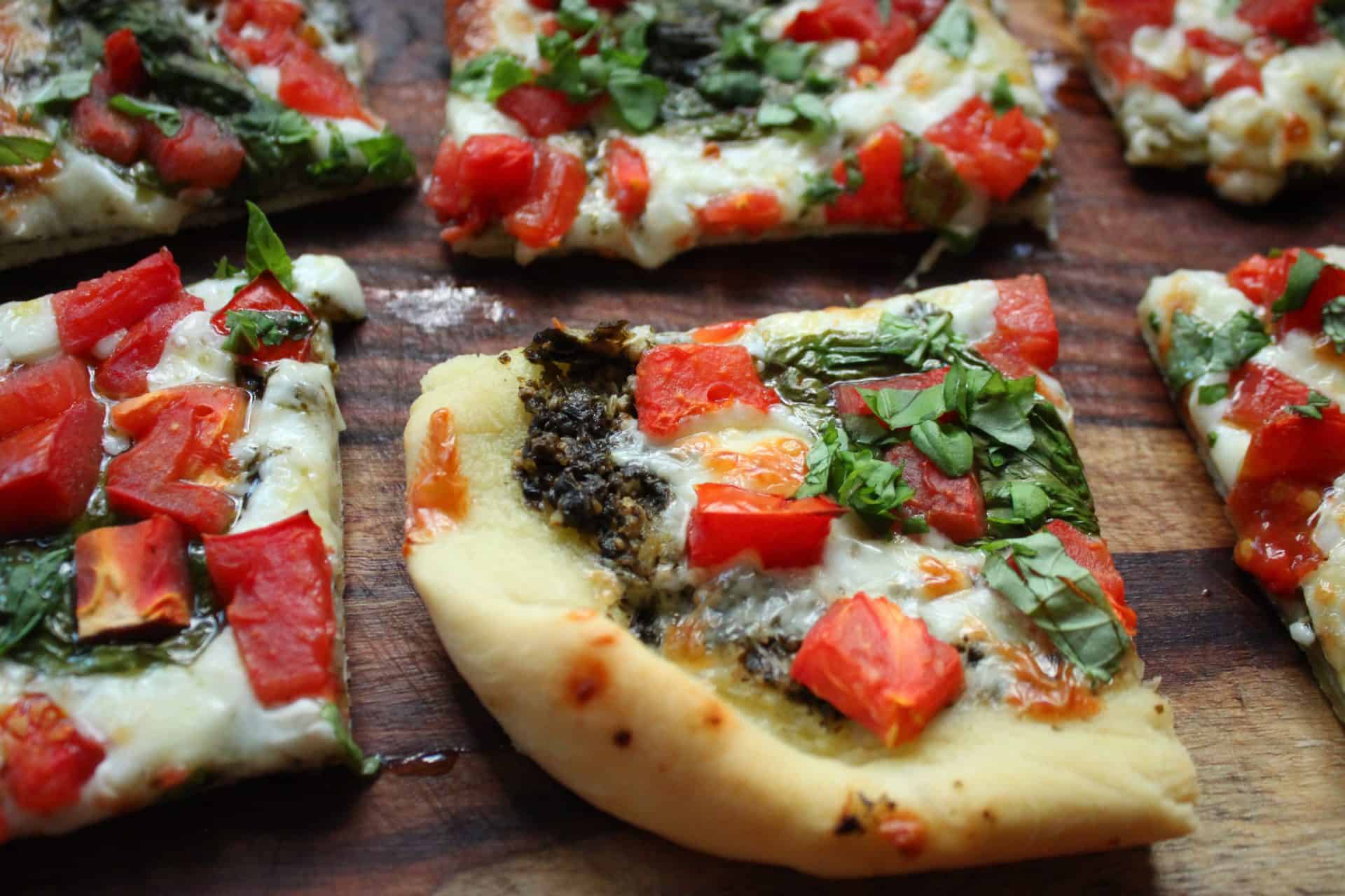 Magic in Minutes: 12 Dinners With 6 Ingredients or Less) 4 Flatbread pizza topped with tomato, pesto, and fresh basil, one of many easy dinners with 6 ingredients or less.