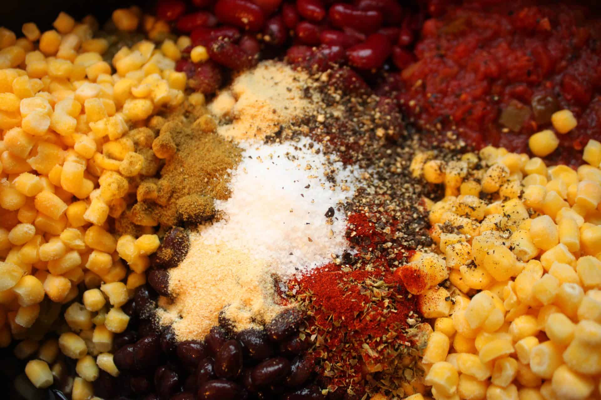 Spices like cumin, chili powder, paprika, and garlic powder added to the Crockpot chicken taco chili before cooking for maximum flavor.