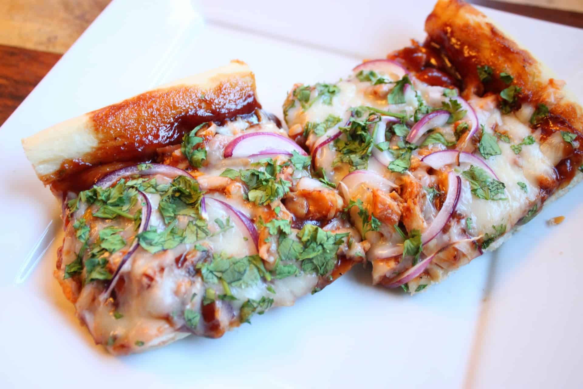 Slices of BBQ Chicken Pizza on a White Plate