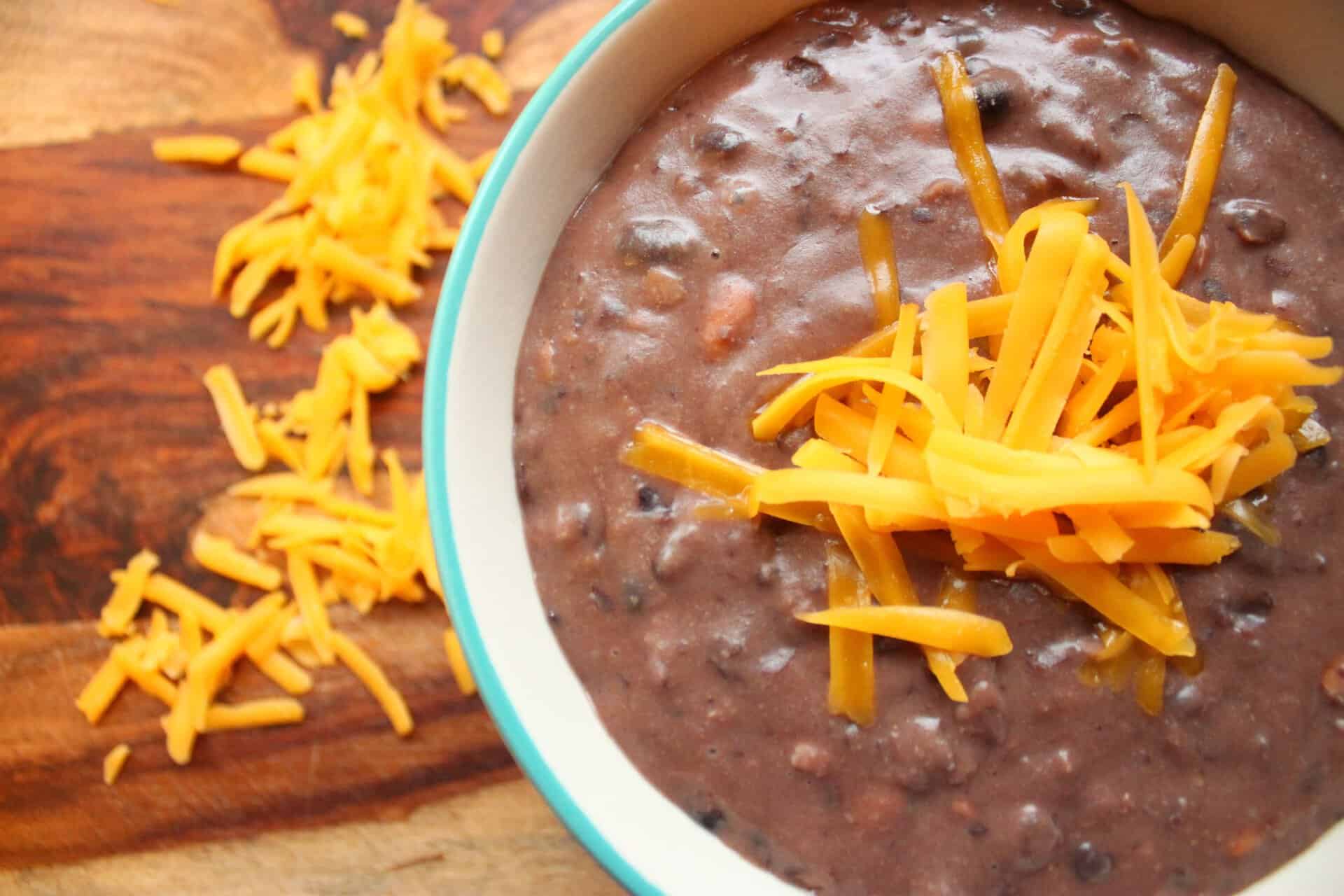 Bowl of Black Bean Dip with Cheddar Cheese Topping