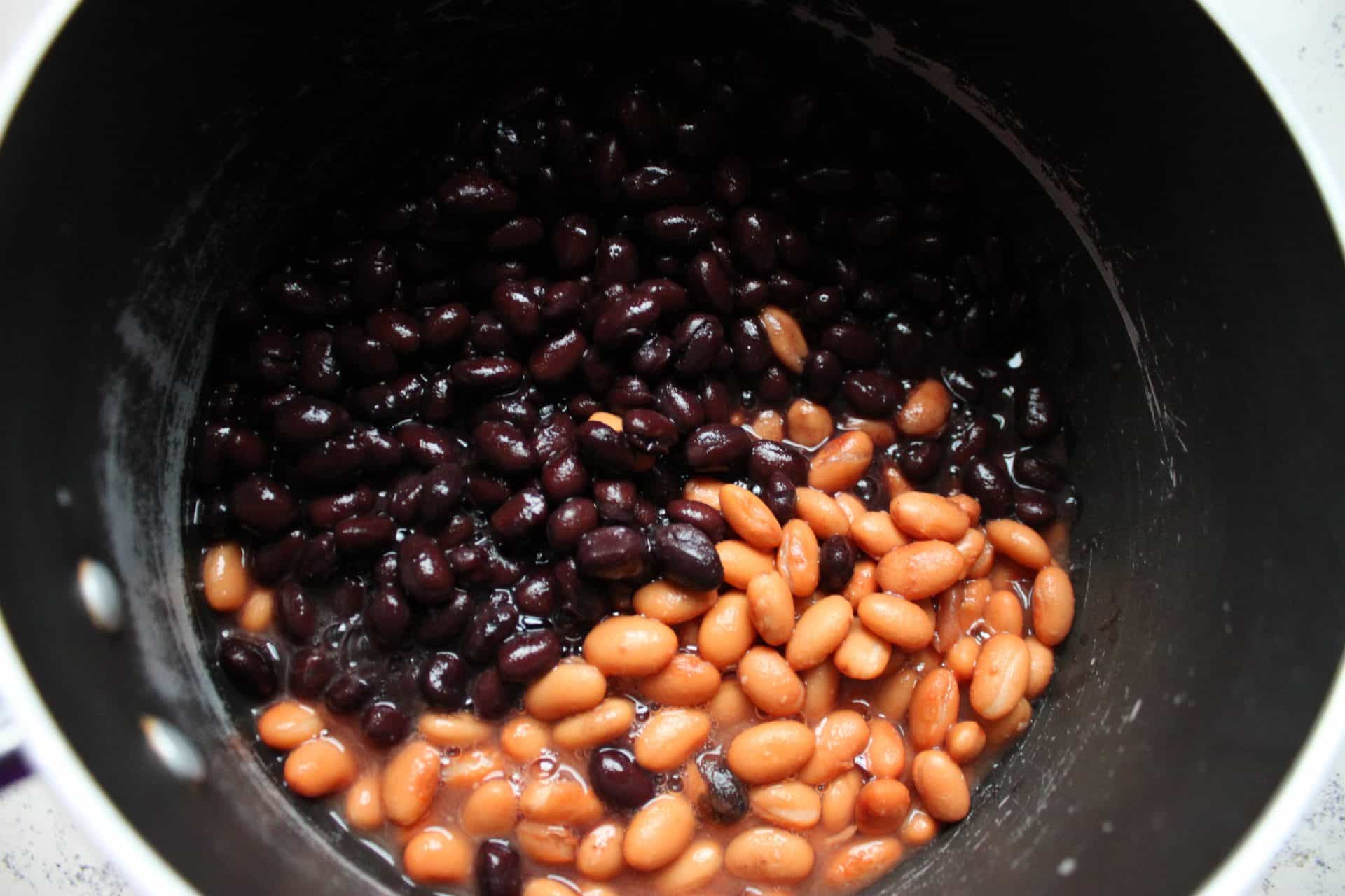 Black and Pinto Beans in the Bottom of a Black Pot