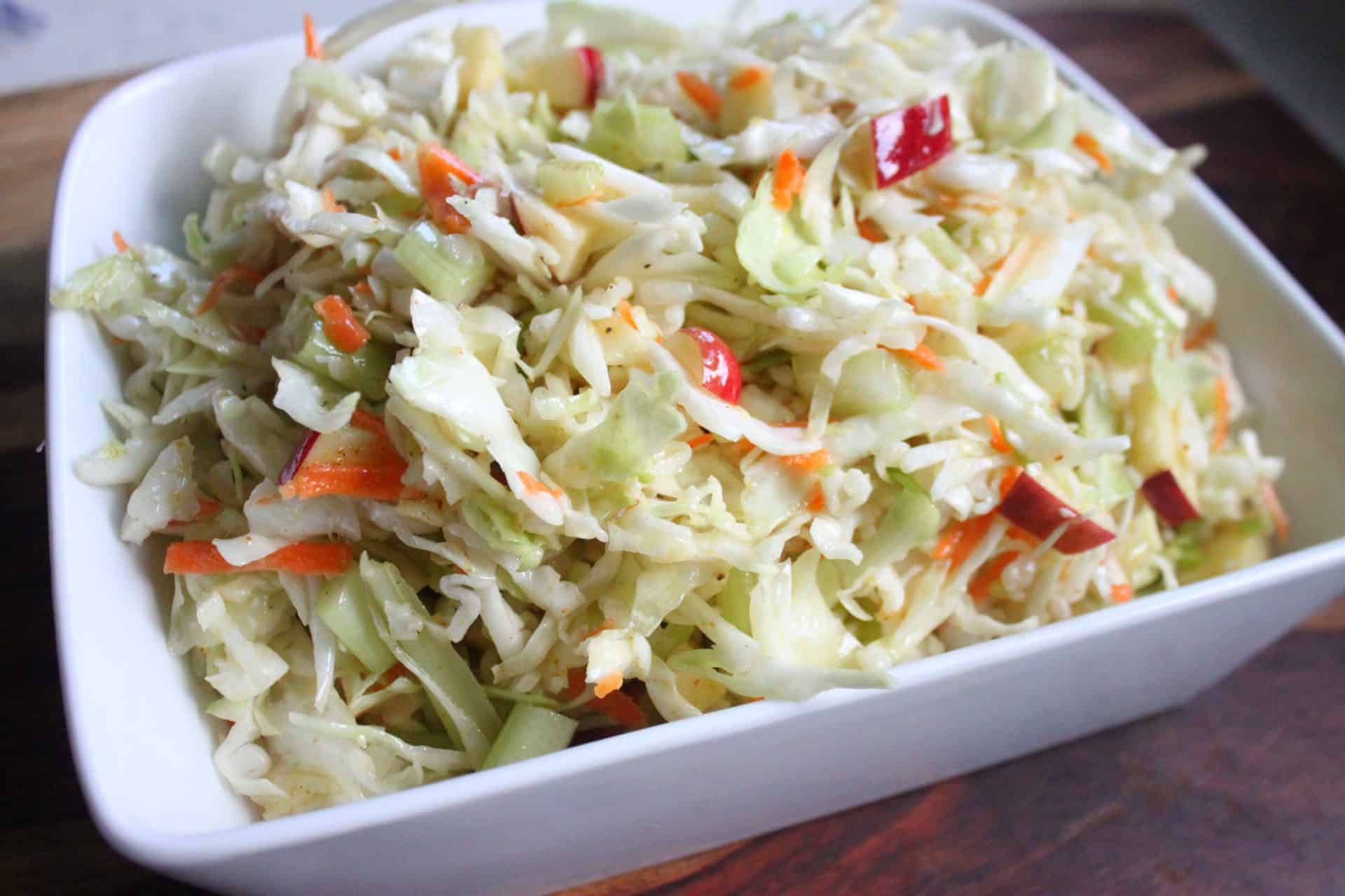 This Crisp Sweet Apple Celery Coleslaw is A Southern Favorite 5 A large bowl of Sweet Apple Celery Coleslaw tossed with crisp cabbage, crunchy celery, and vibrant red apple pieces.