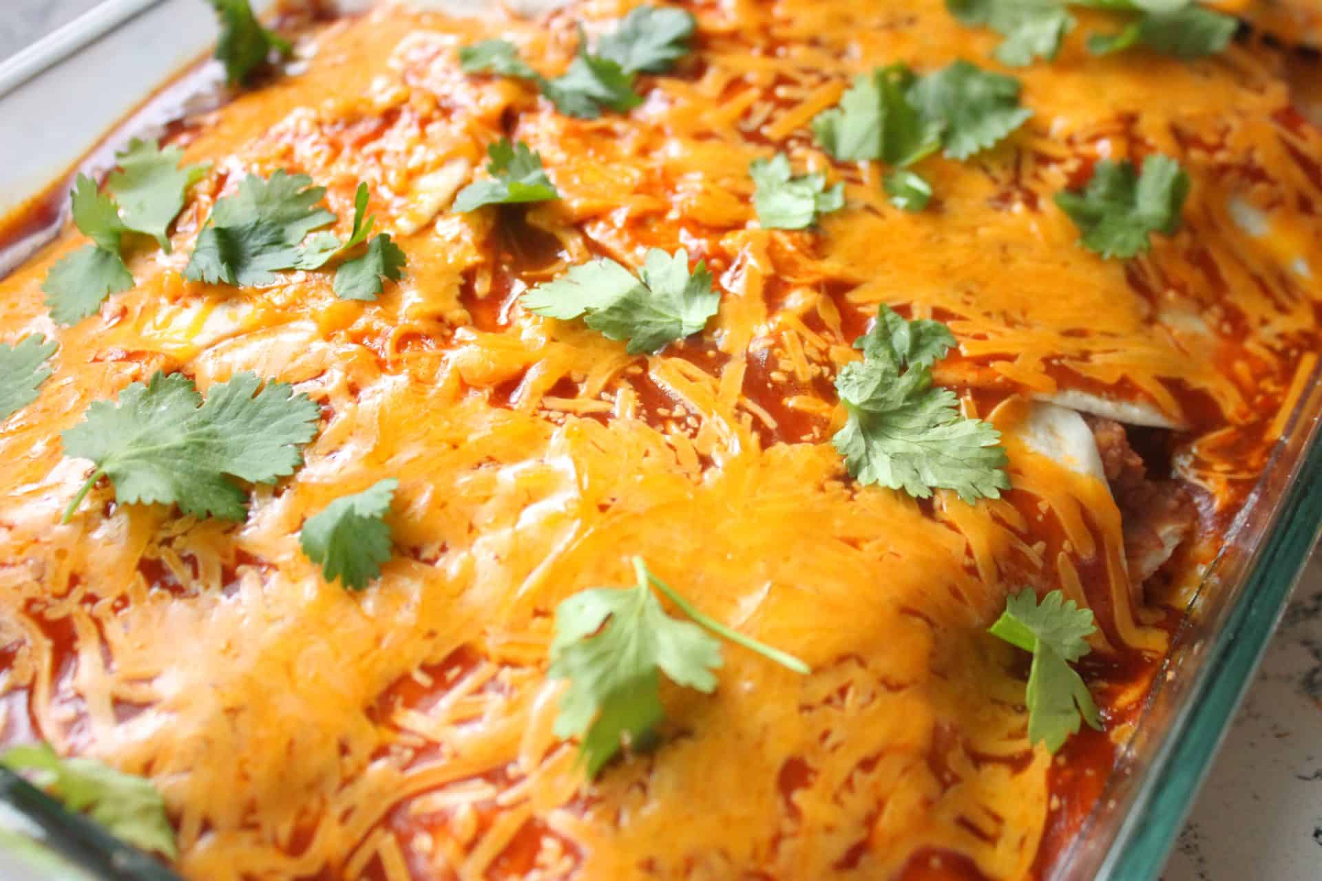 The Budget-Friendly Burrito Lasagna That Feeds 12 for $10 7 Burrito Lasagna Baked in Clear Casserole Dish
