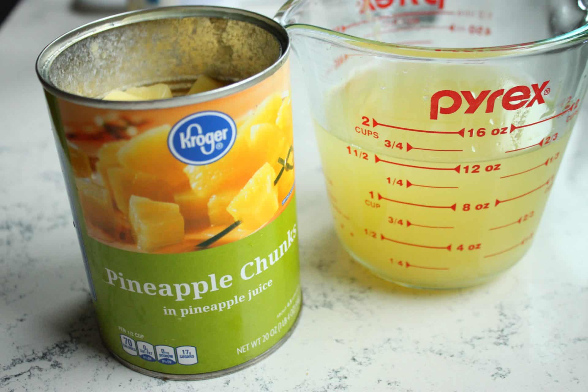 Crockpot Hawaiian Meatballs: Sweet, Savory, and Effortless to Make 3 Canned Pineapple Chunks and Pineapple Juice in Pyrex Measuring Cup