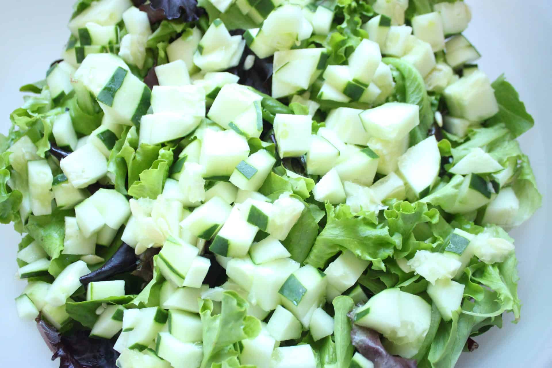 Flavor-Packed 30-Minute Grilled Chicken Artichoke Salad You'll Love 1 Chopped Lettuce and Cucumbers in a Large Plastic Bowl