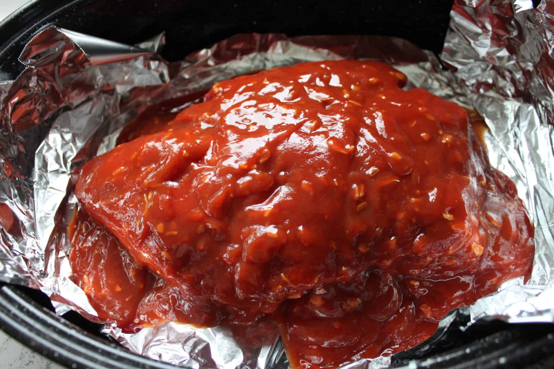 Irresistible 4-Ingredient Slow Cooked Chuck Roast for Easy Dinners 3 Chuck Roast with Ketchup Mixture on Top Sitting in a Roasting Pan