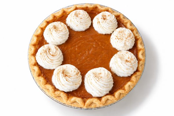 Overhead view of pumpkin pie with golden crust and smooth orange pumpkin filling.