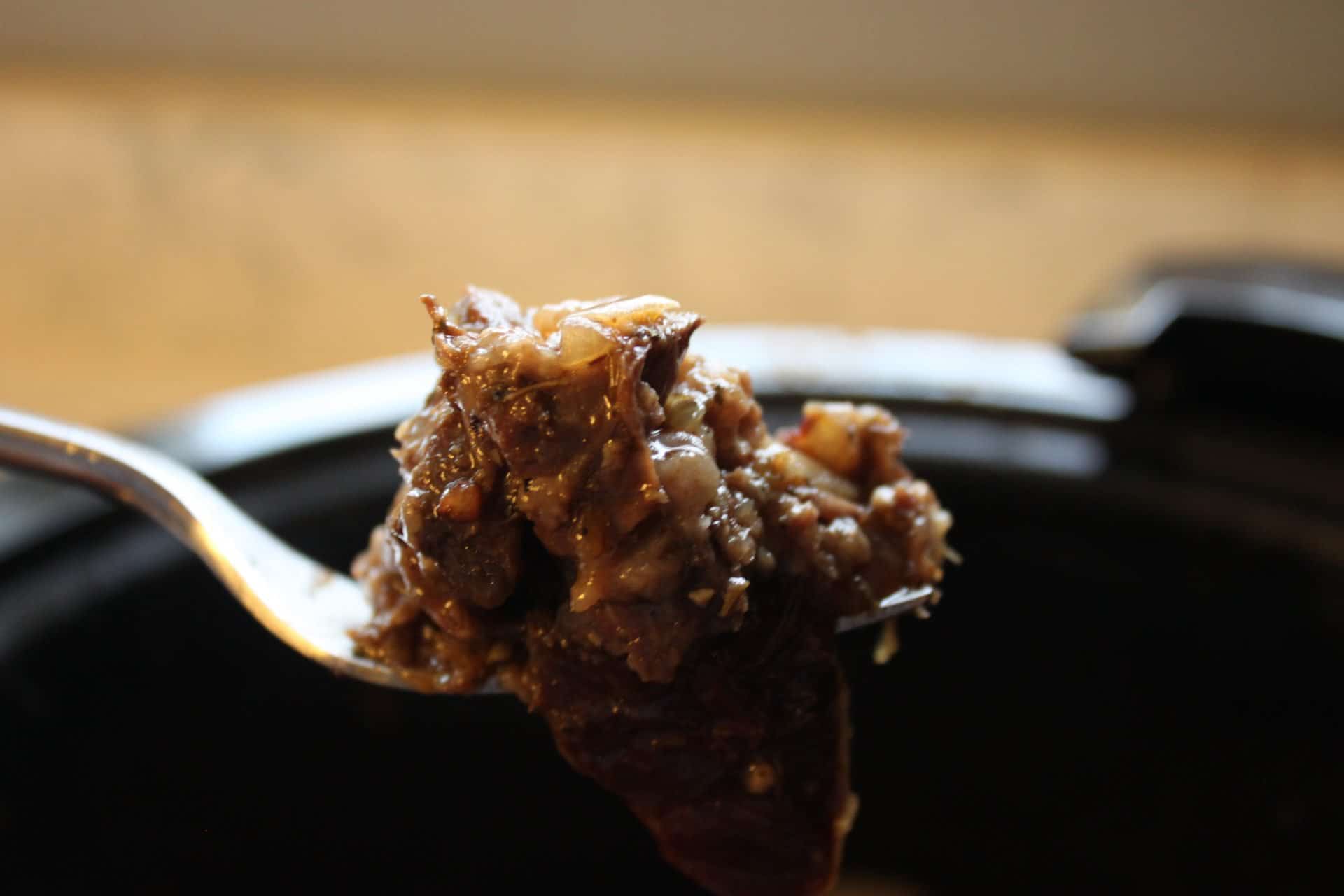 Close Up of Cooked Crockpot Cooked Chuck Roast on a Metal Fork