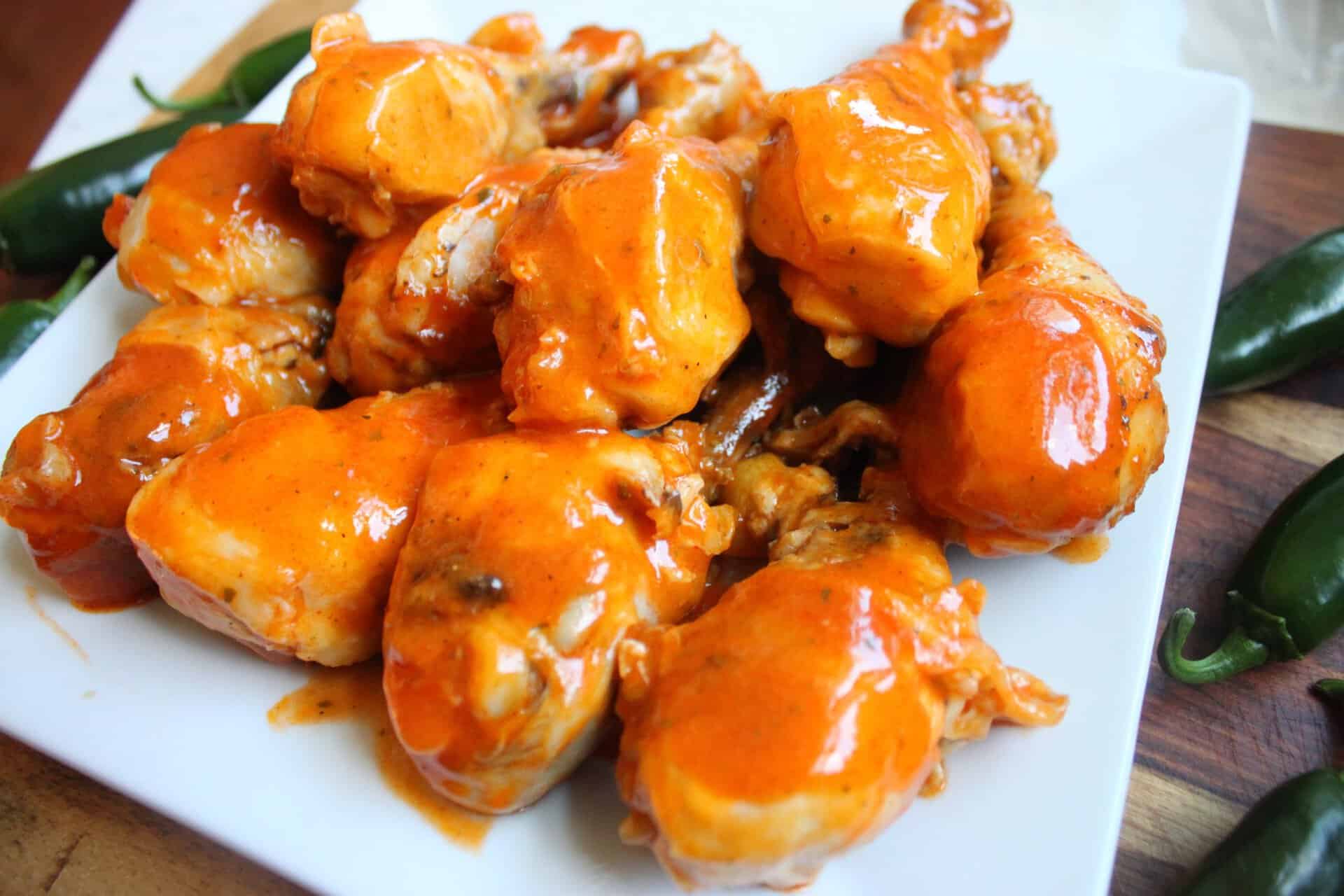 White Plate Filled with Crockpot Buffalo Drumsticks