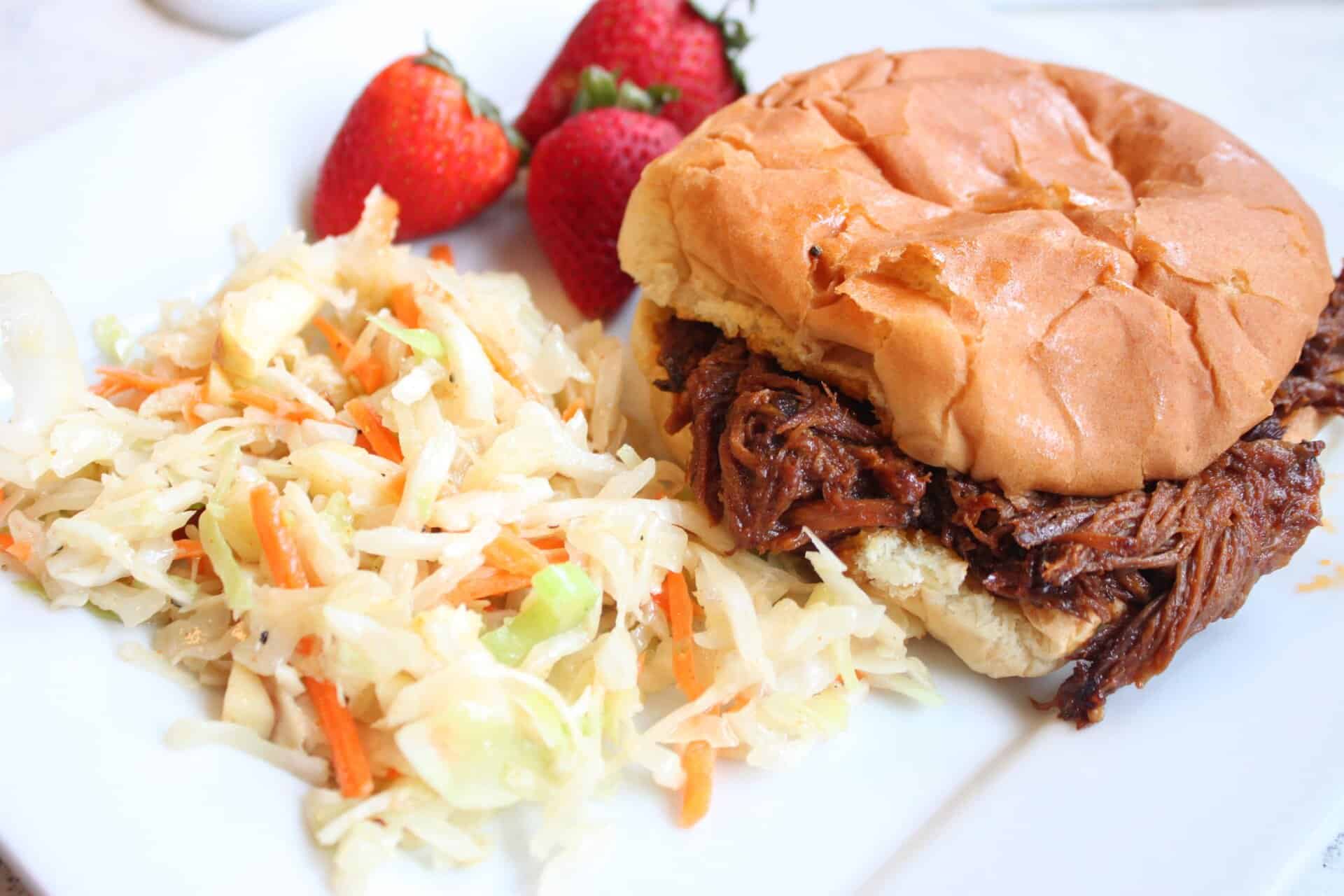 Crockpot Pork Shoulder Sandwich Sittin on White Plate