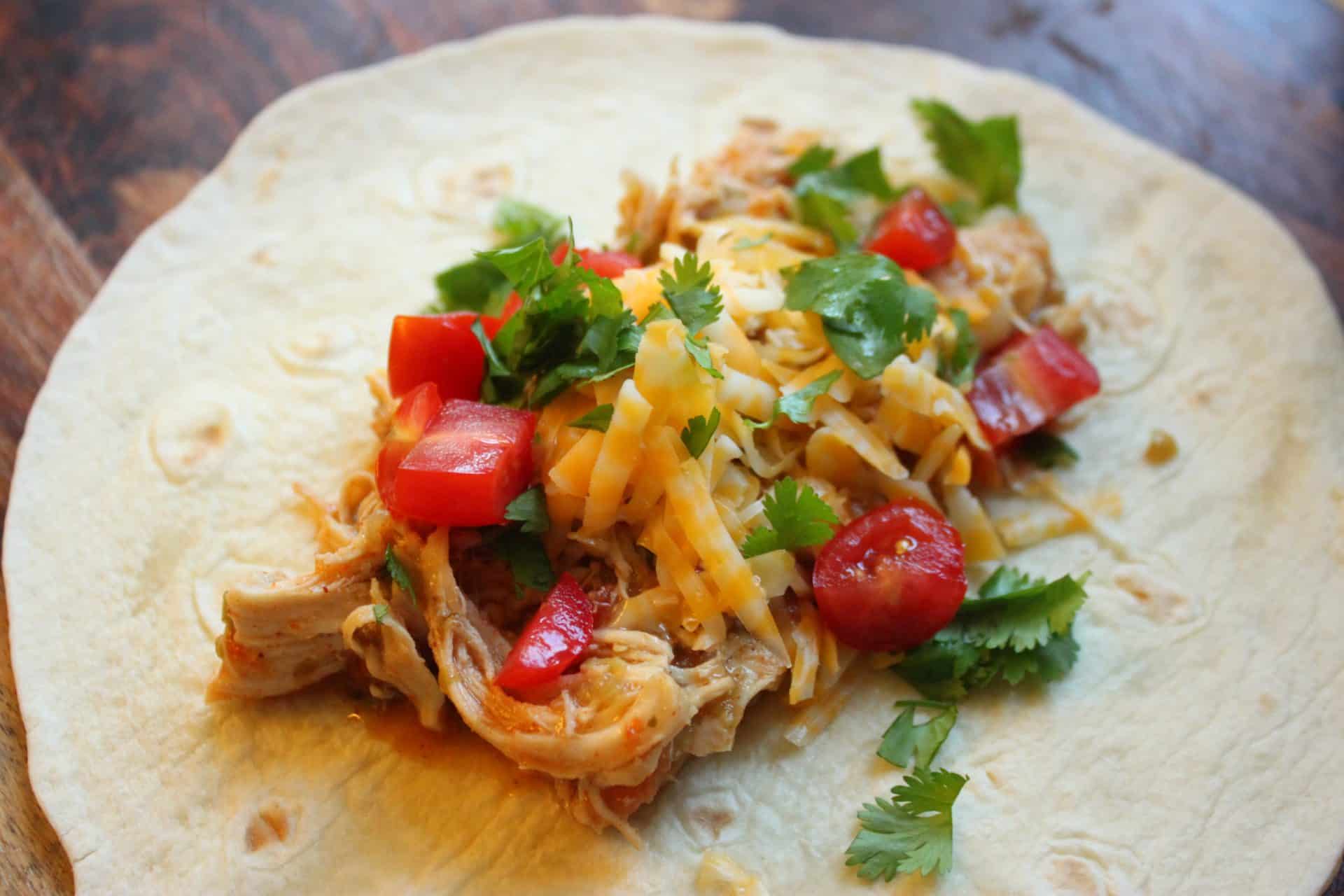 Crockpot Salsa Verde Chicken Burrito on a Wood Counter