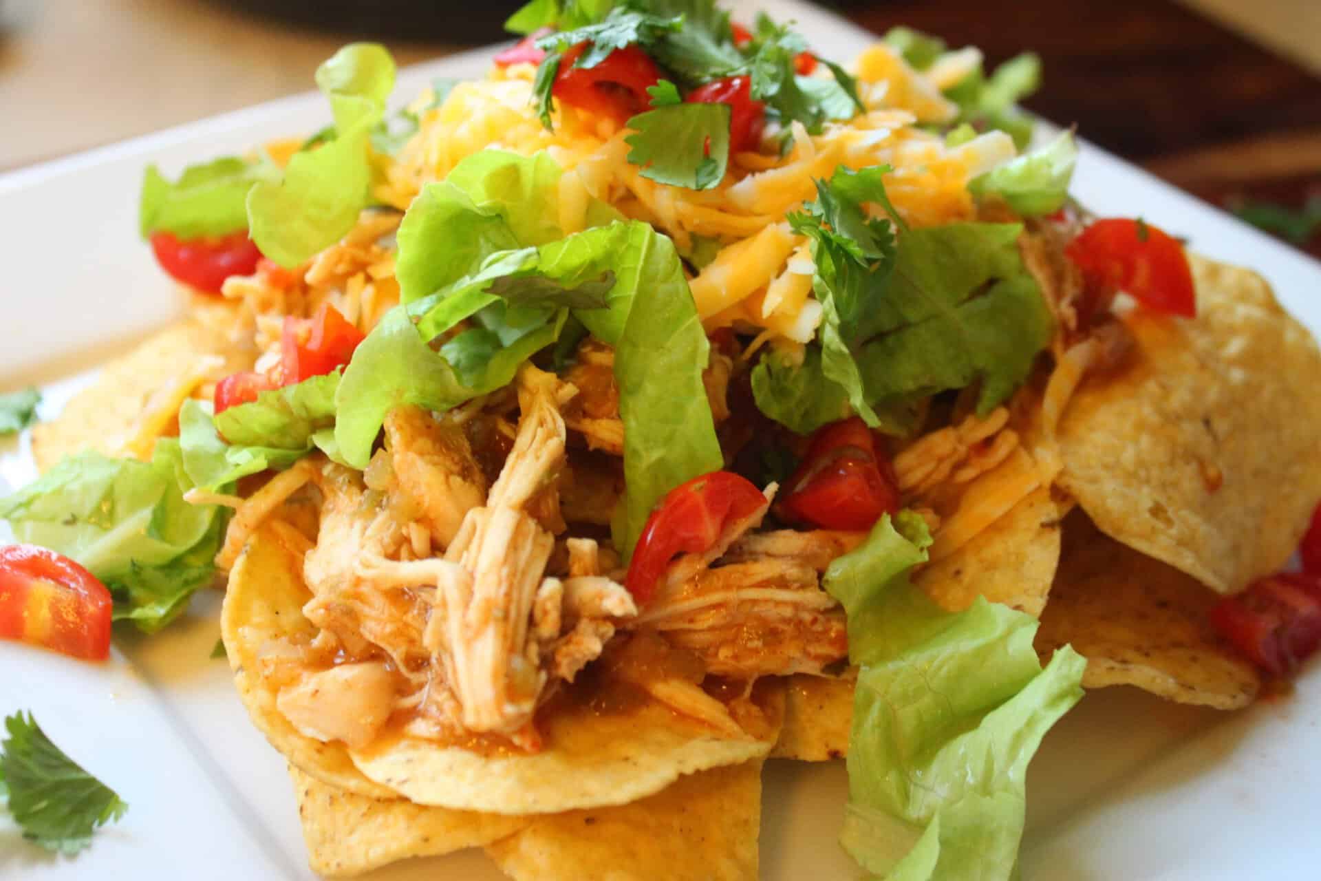 Crockpot Salsa Verde Chicken Nachos on a White Plate