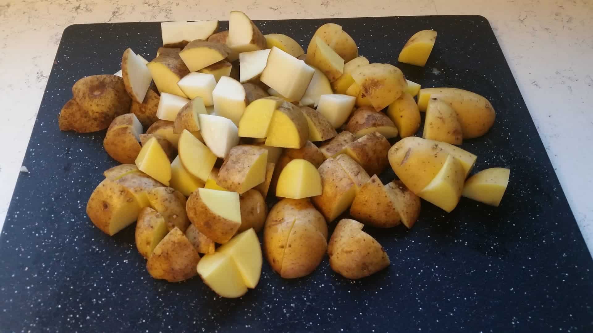 Cubed Potatoes on a Black Cutting Board