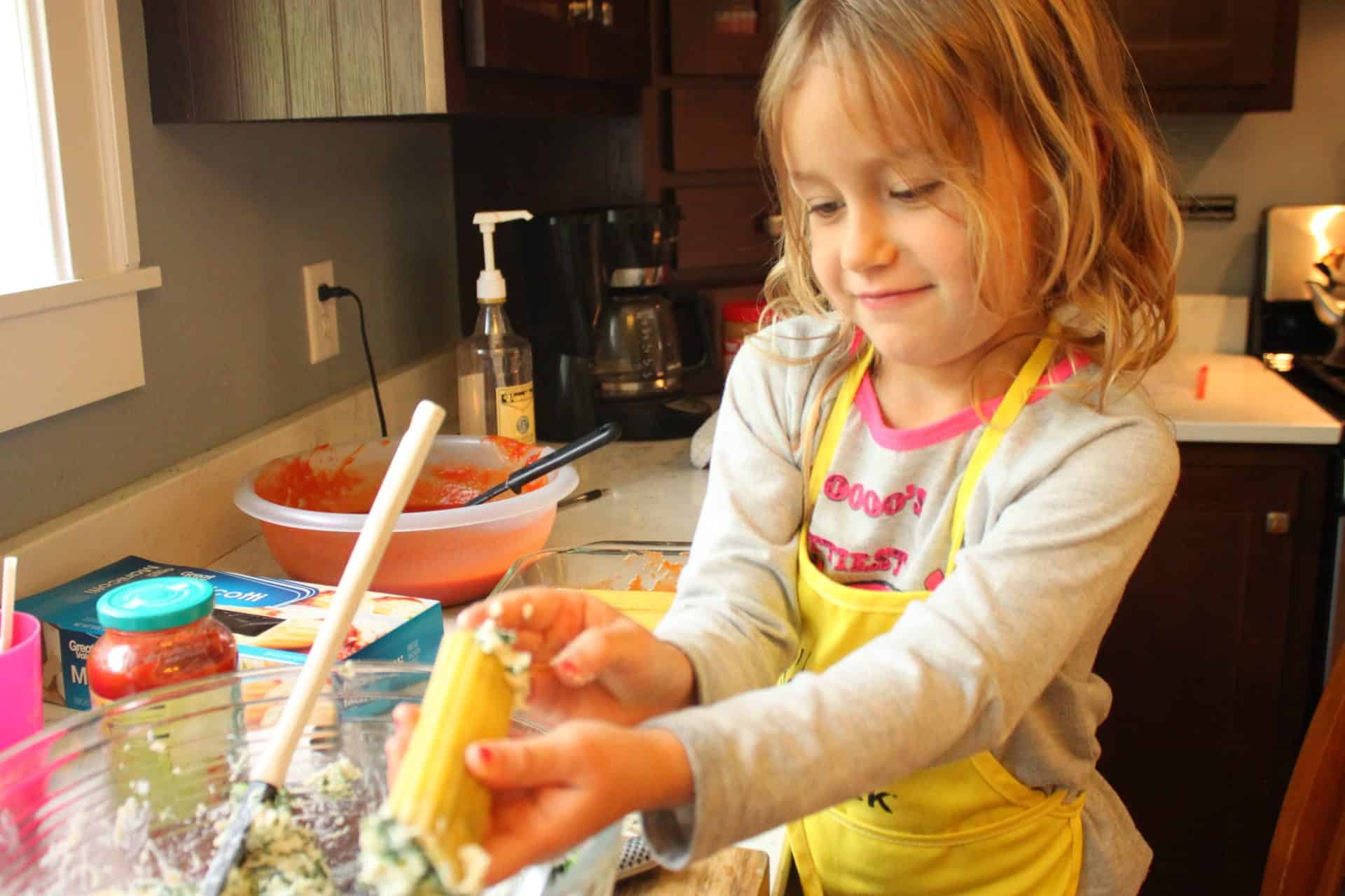Freezer-Friendly Spinach Manicotti: A Comfort Meal for New Moms 4 Daughter Stuffing Manicotti Shells with Spinach Filling