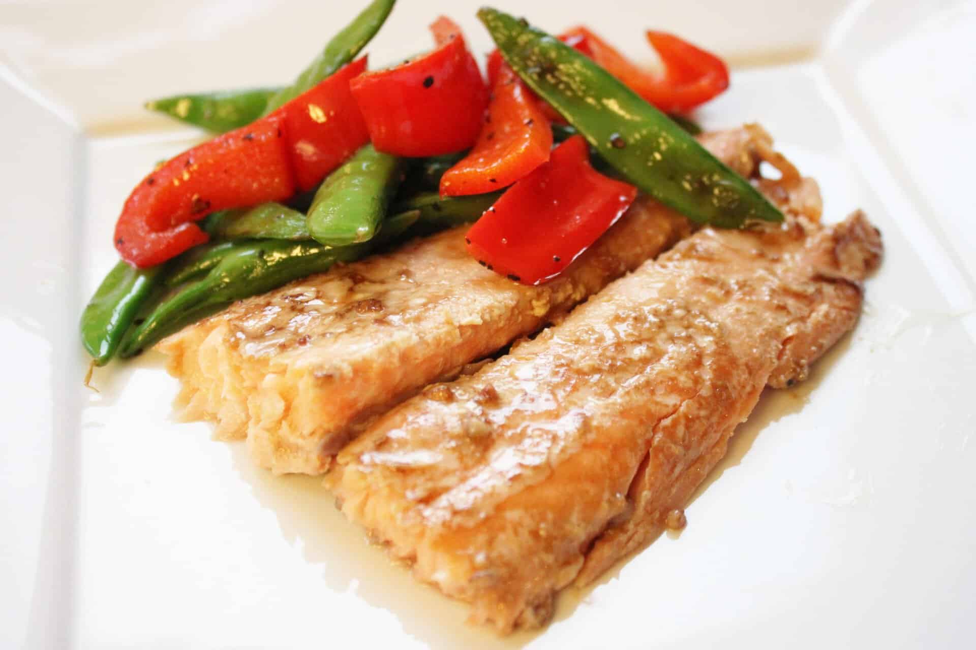 Dijon Salmon and Sauteed Snap Peas on White Plate