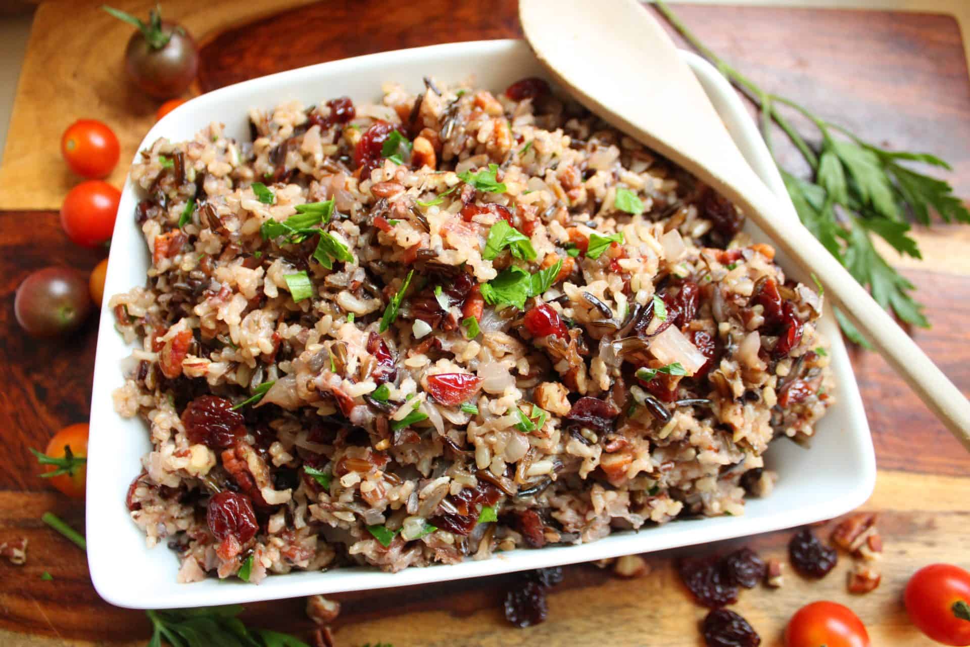 Crockpot Wild Rice with Cherries and Pecans: A Delicious Twist 5 Serving spoon in Crockpot wild rice with cherries and pecans, showing the hearty texture and colorful mix of grains, fruit, and nuts.