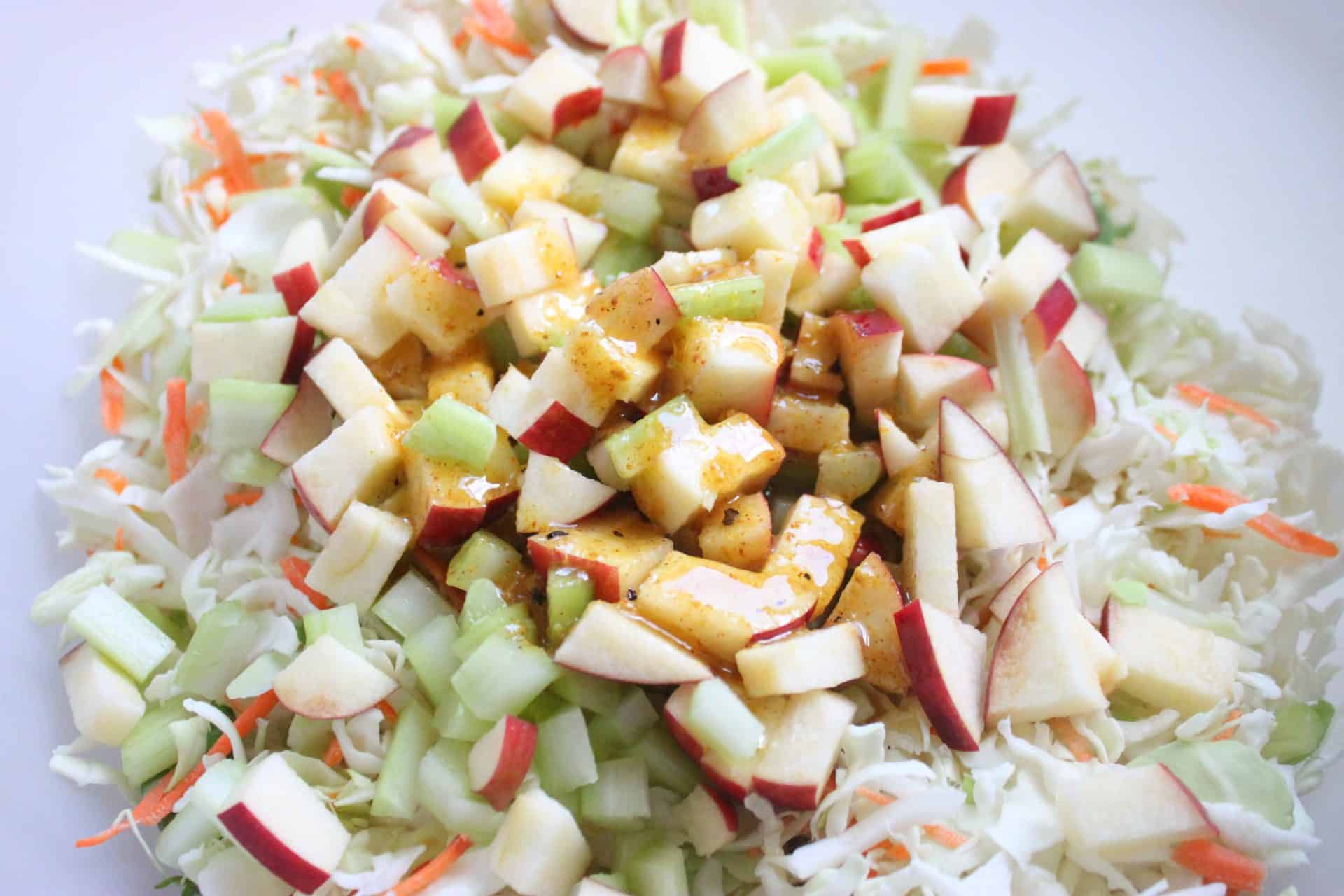 This Crisp Sweet Apple Celery Coleslaw is A Southern Favorite 4 Sweet Apple Celery Coleslaw with the golden dressing drizzled over the crunchy mix of cabbage, celery, and diced apples.