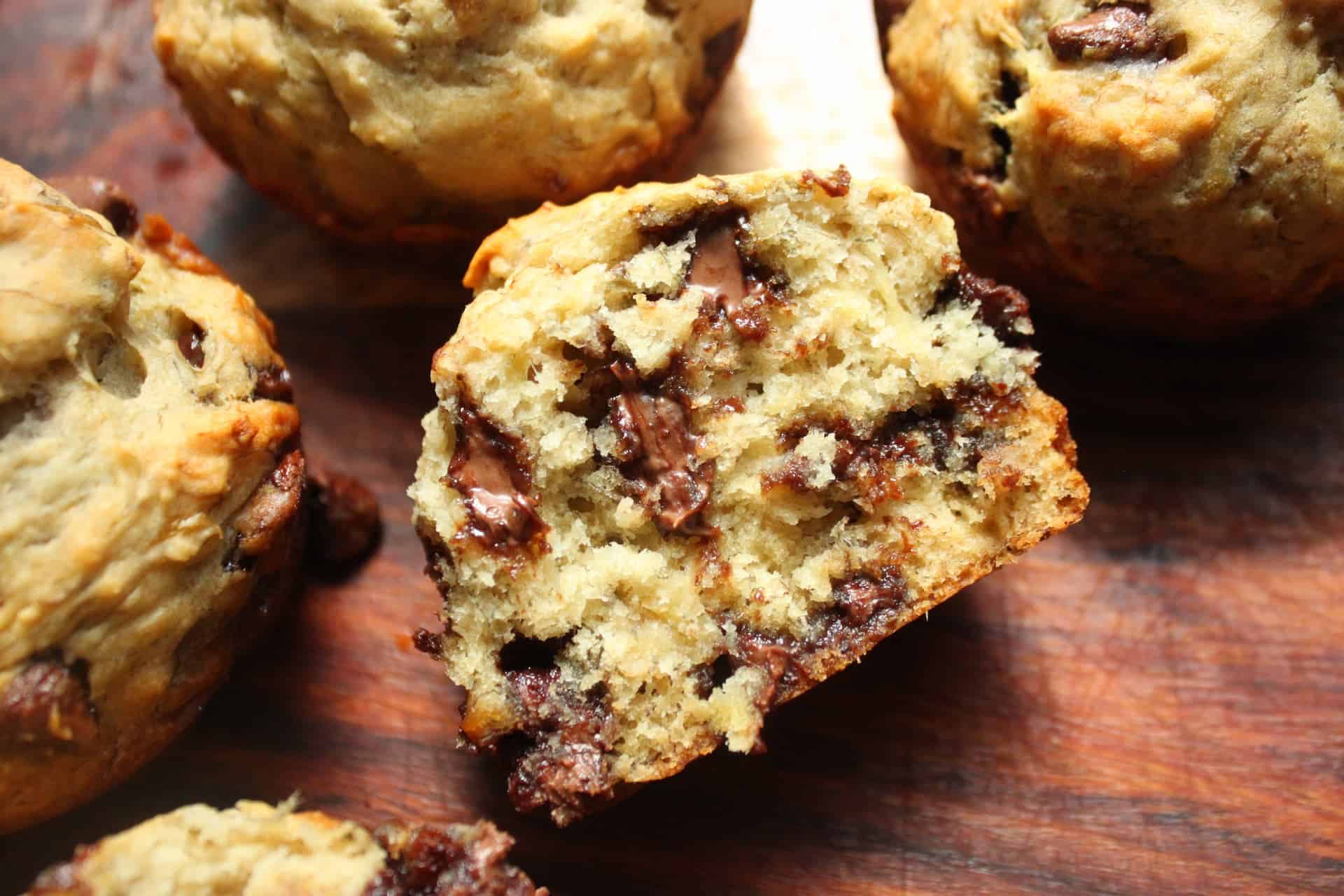 Extra Fluffy Banana Chocolate Chip Muffins Broken Open to Reveal the Soft Warm Inside