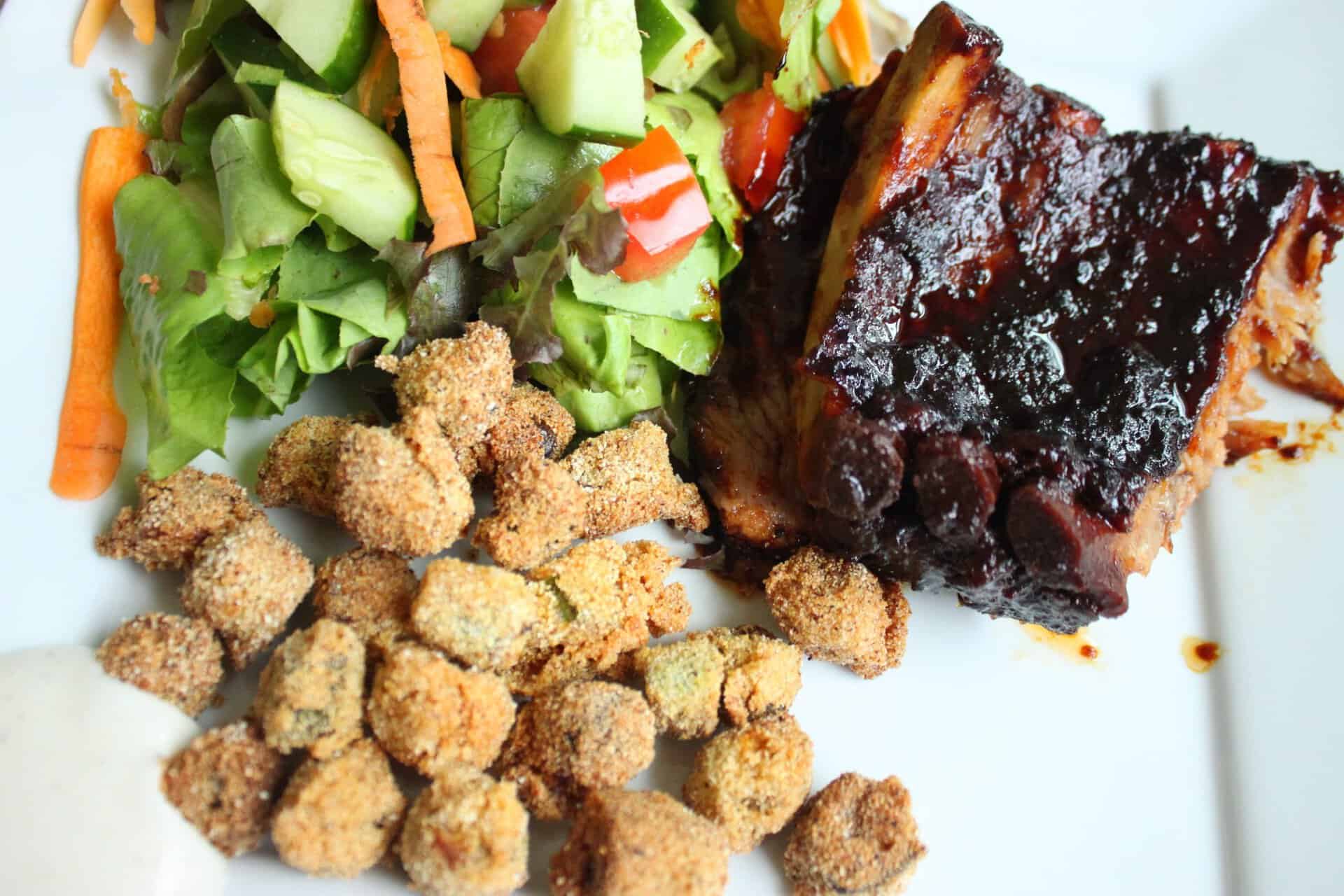 White Plate with Fried Okra with a Side of Salad and Pork Ribs