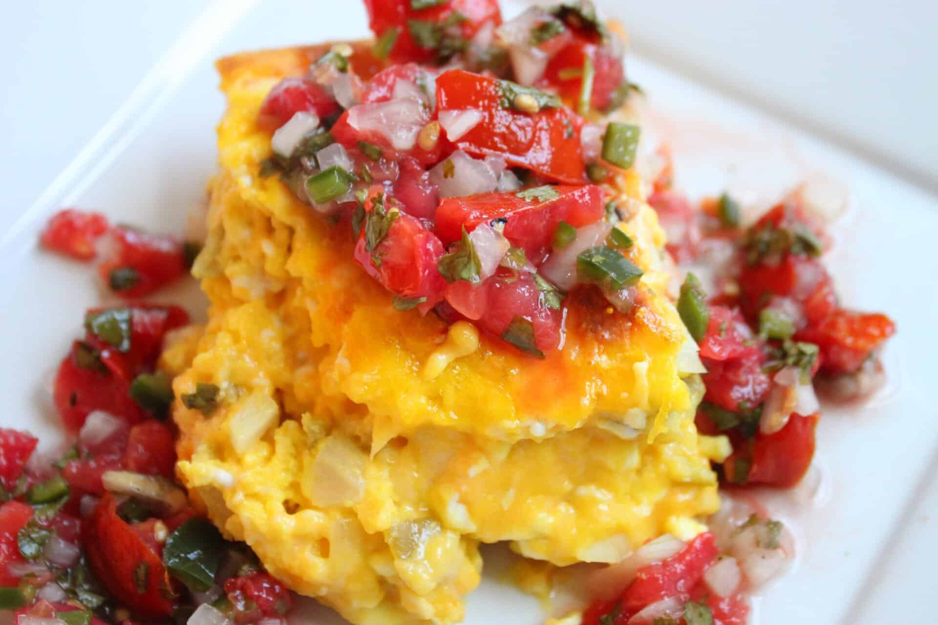 Is Green Chile Cheese Quiche a Dinner or Breakfast Food? 9 Close-up of a delicious Green Chile Cheese Quiche topped with fresh salsa, perfect for any meal of the day.