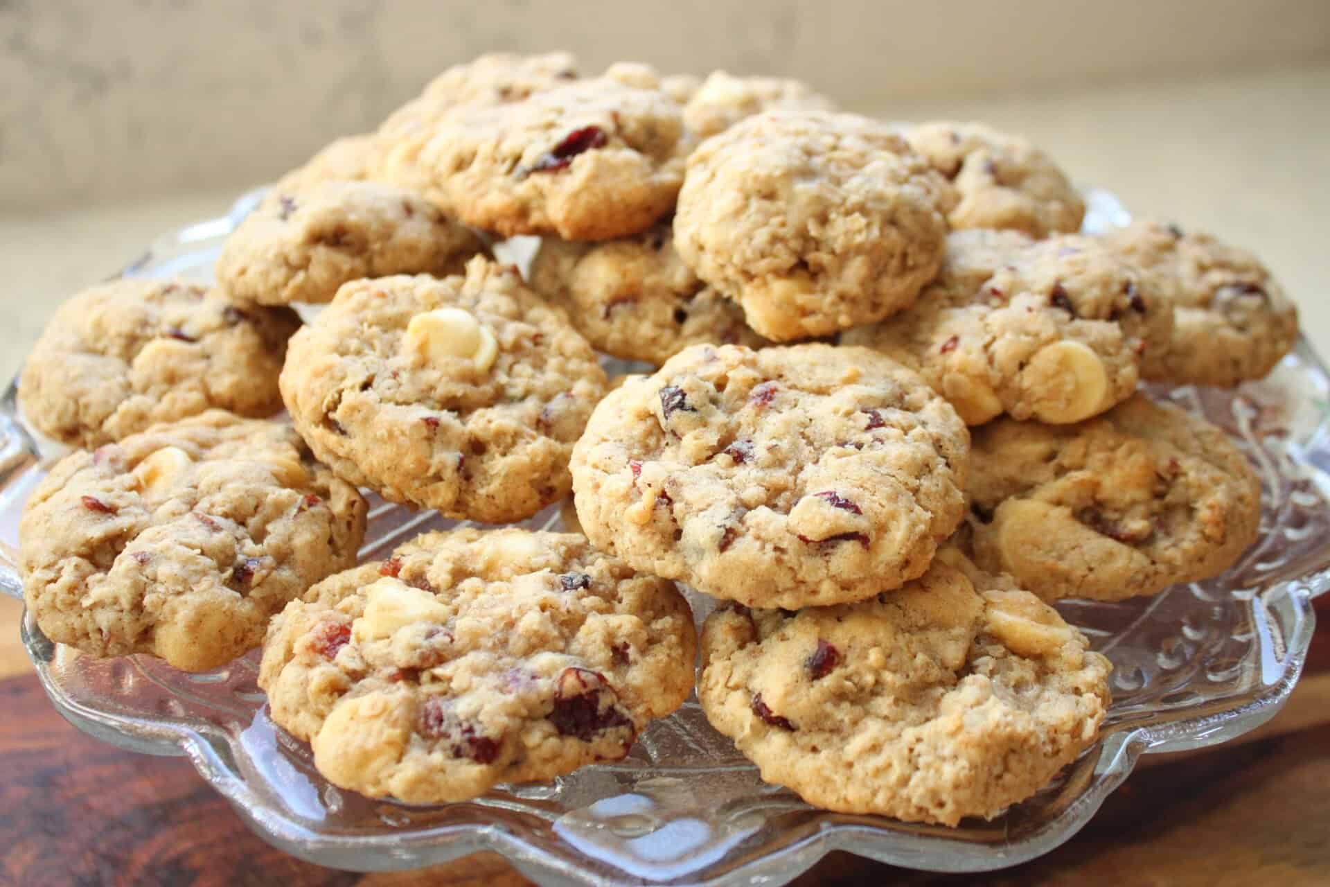Discover the Sweet Magic of White Chocolate Oatmeal Cookies 9 A platter of white chocolate oatmeal cookies stacked high, brimming with white chocolate chips and dried cranberries for a perfect snack.