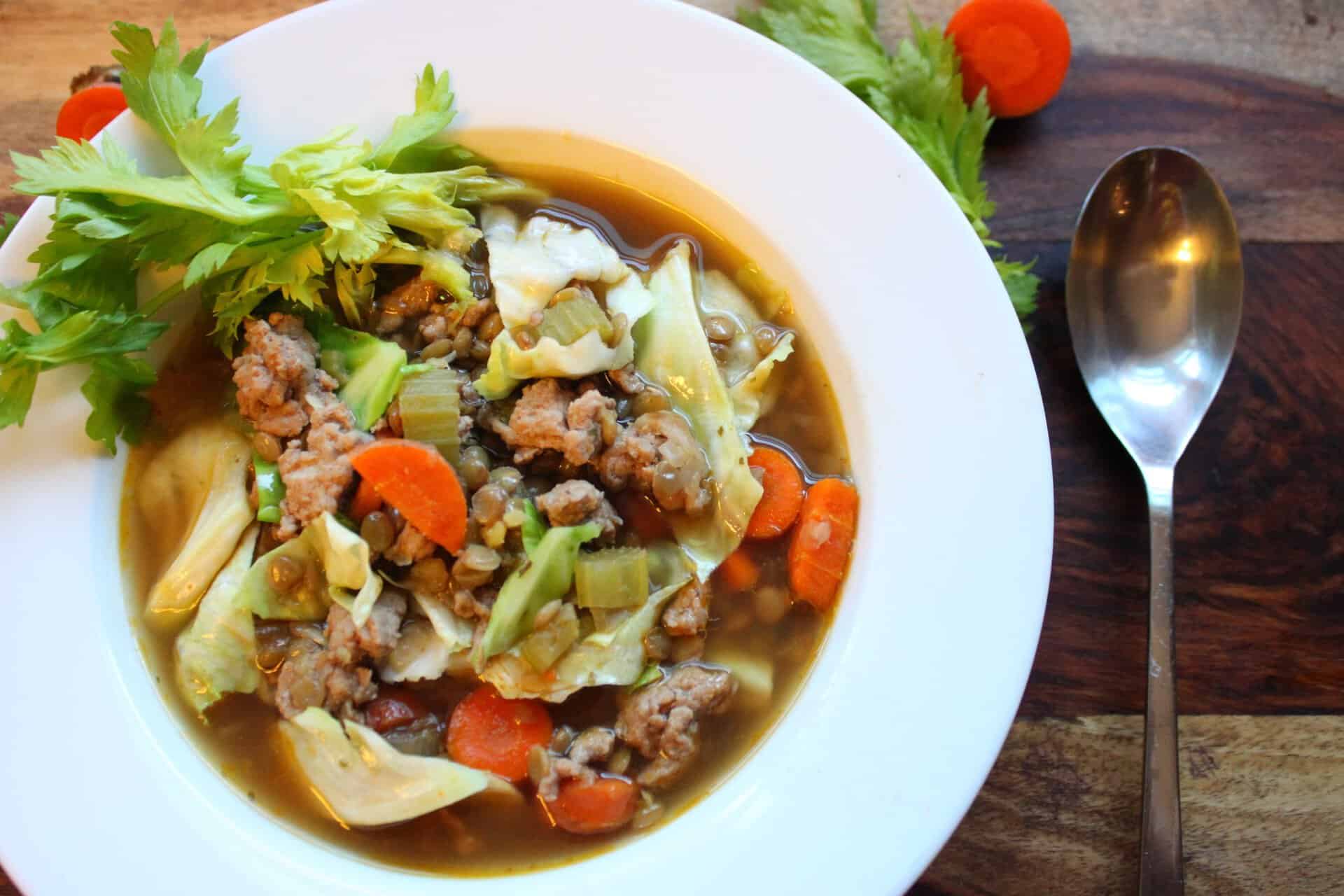 Heartwarming Cozy Italian Sausage and Lentil Soup 12 Italian Sausage and Lentil Soup in a White Bowl with a Spoon