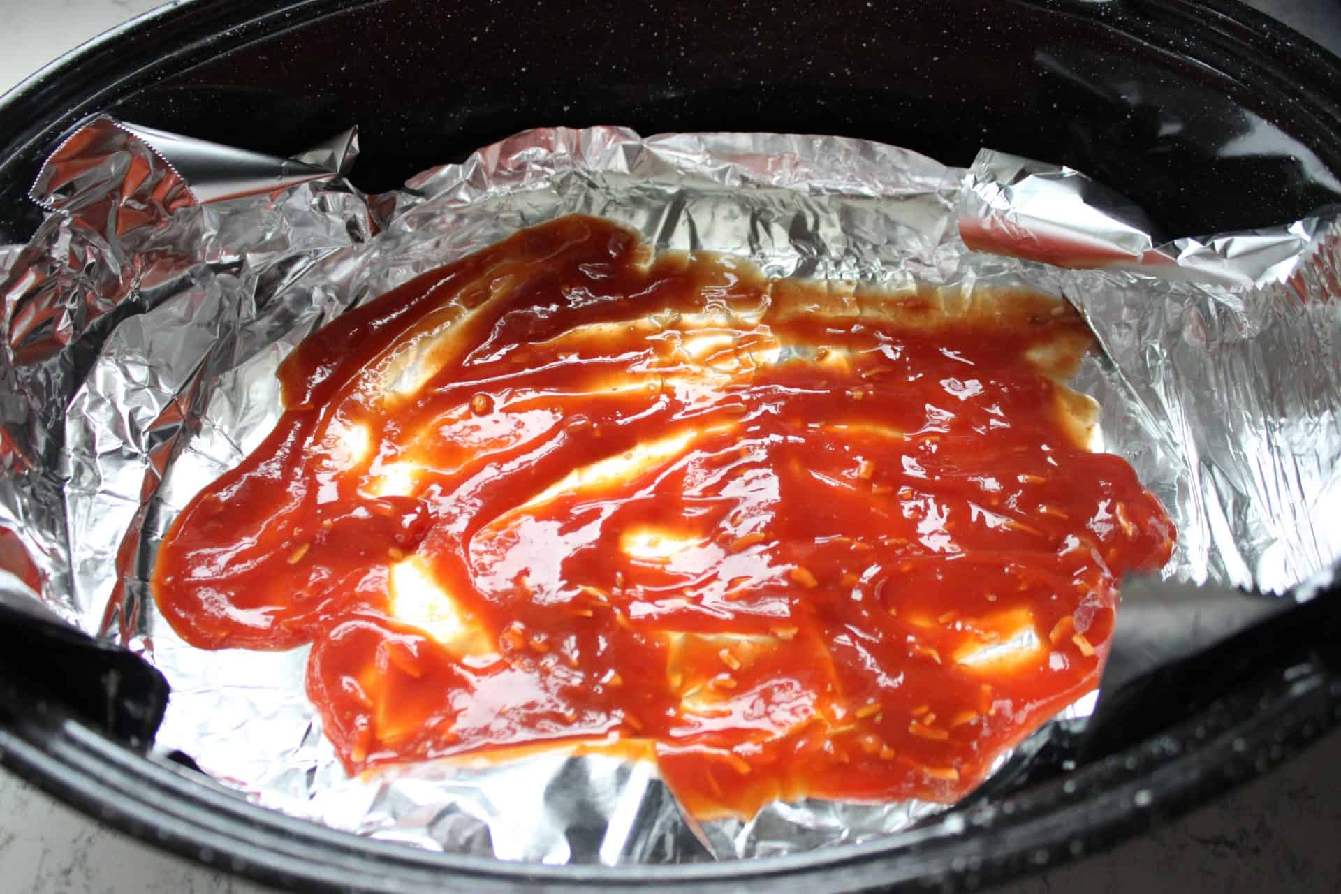 Irresistible 4-Ingredient Slow Cooked Chuck Roast for Easy Dinners 2 Ketchup on Foil in a Roasting Pan