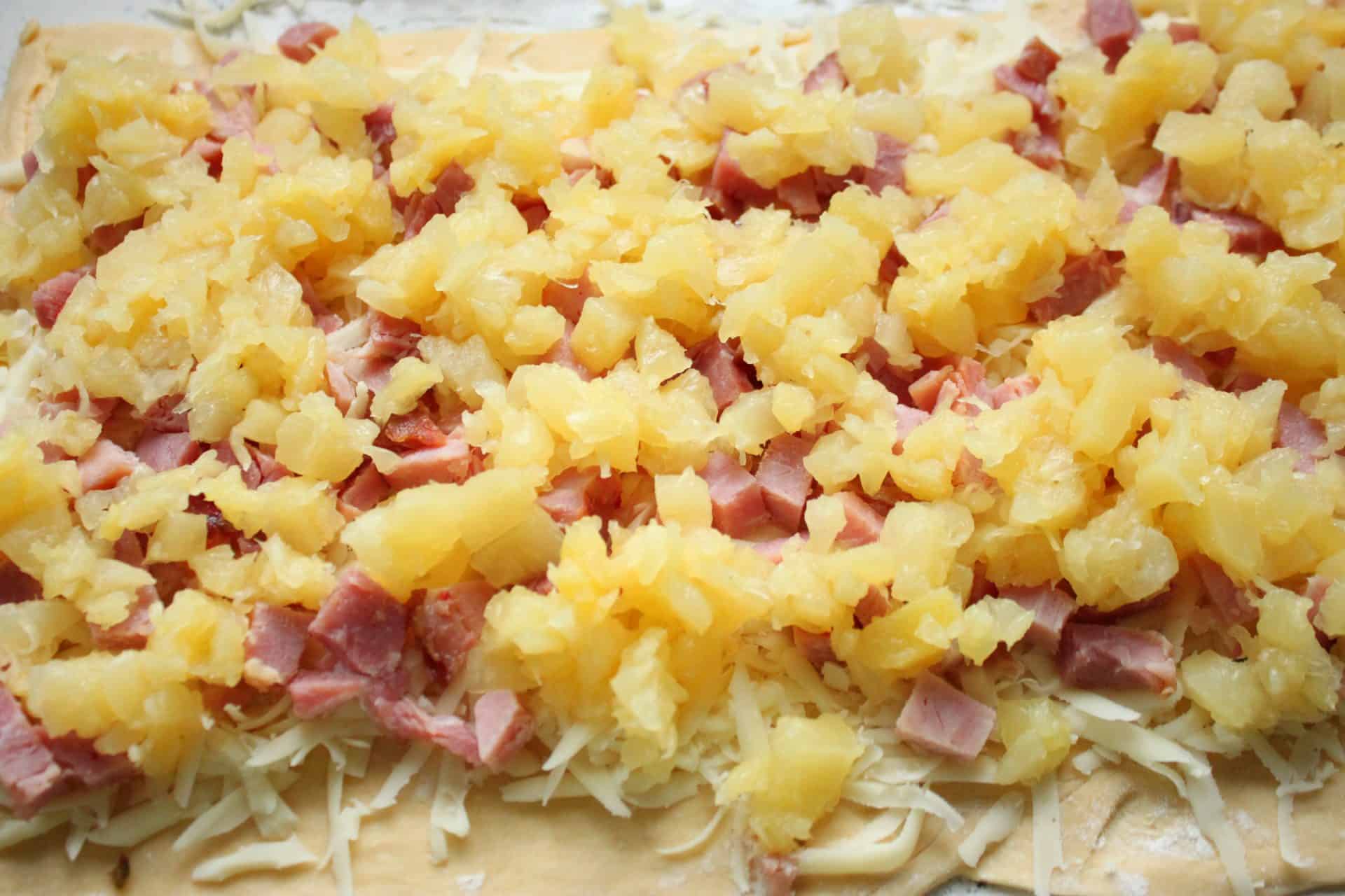 Savory and Sweet Ham and Pineapple Pinwheels for the Family 4 Evenly spread diced ham and shredded pineapple on top of mozzarella-covered crescent dough, ready to roll into pinwheels.