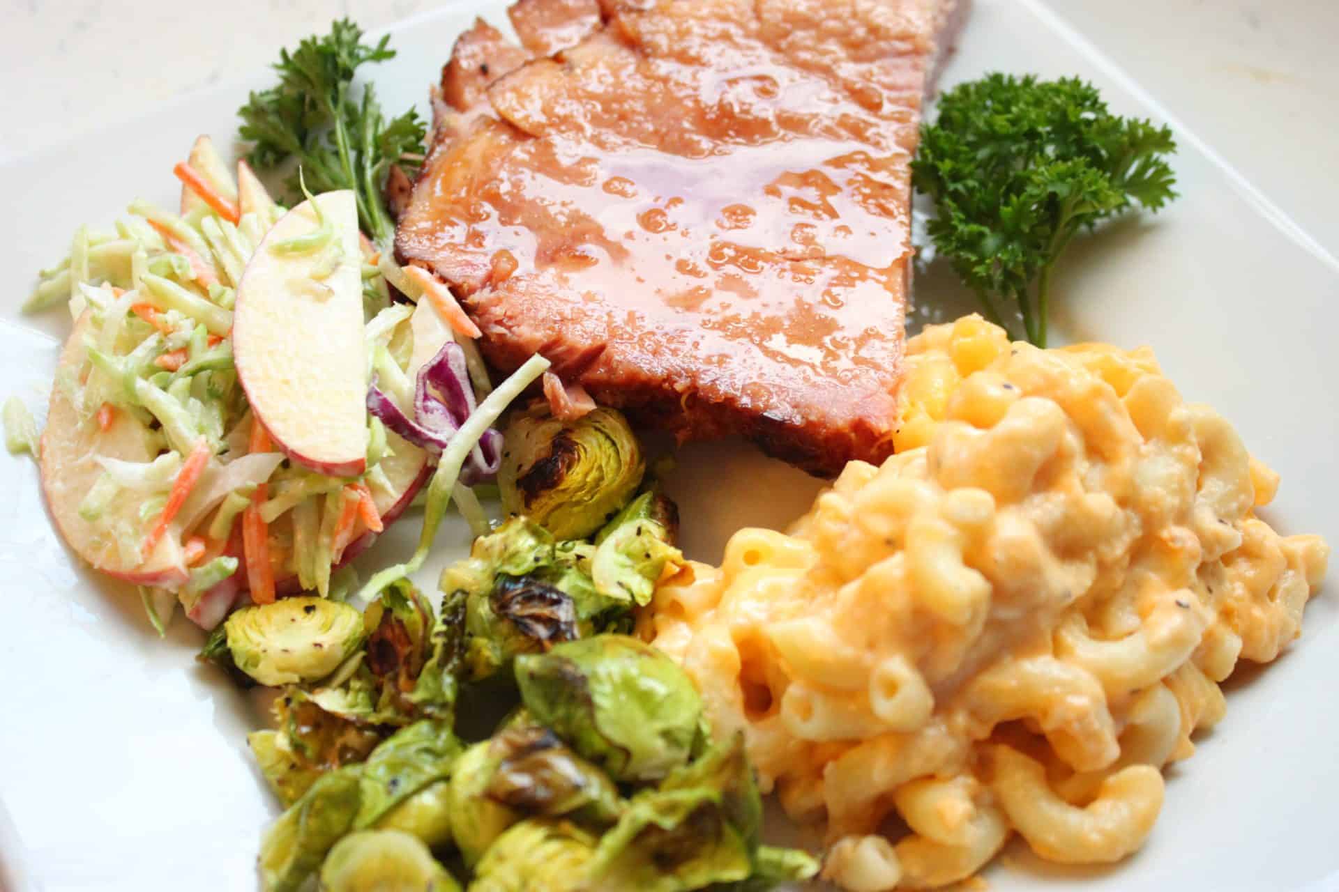 Macaroni, Glazed Ham, and Brussel Sprouts on a Square White Plate