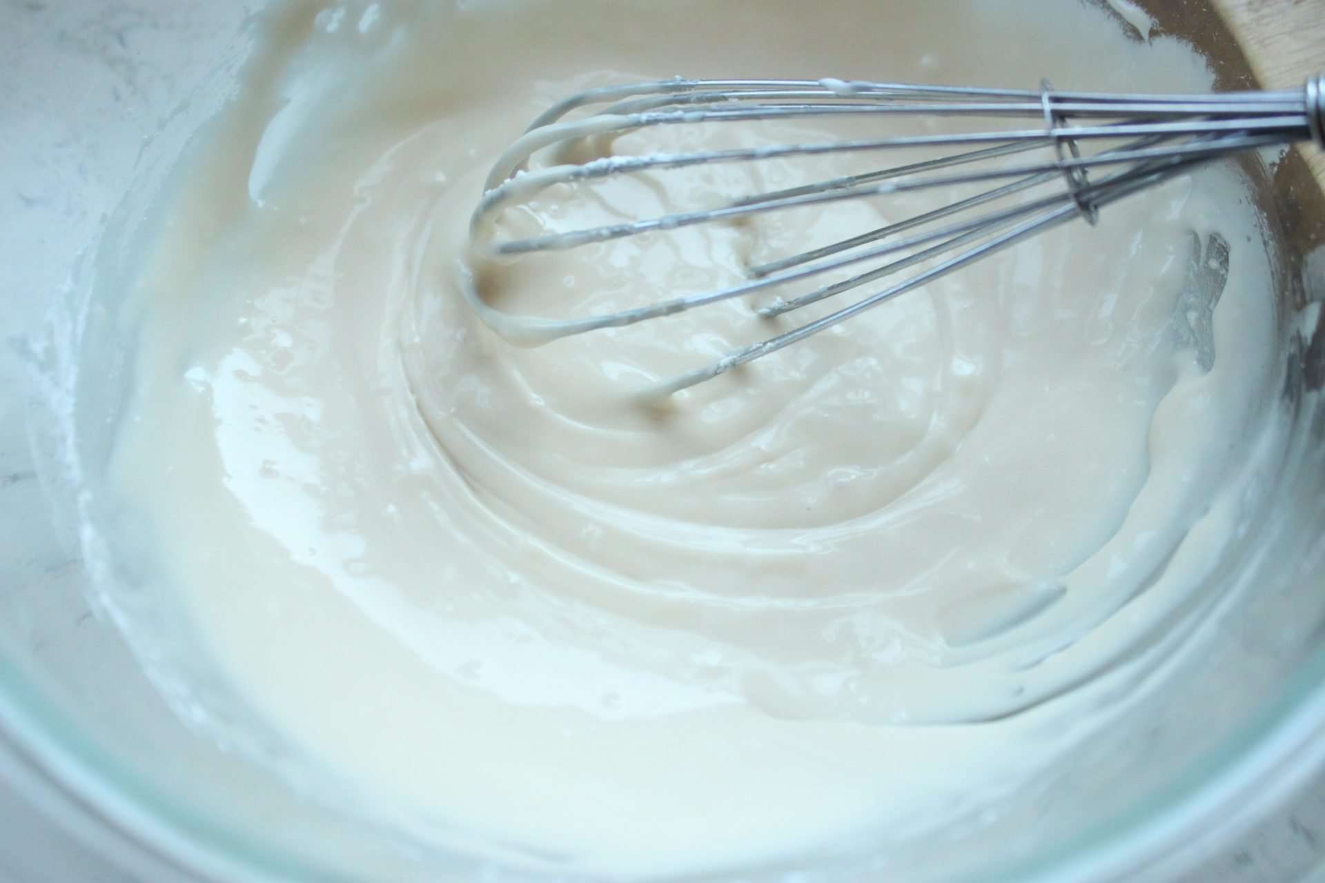Mixing Vanilla Frosting with a Whisk for Pumpkin Muffins