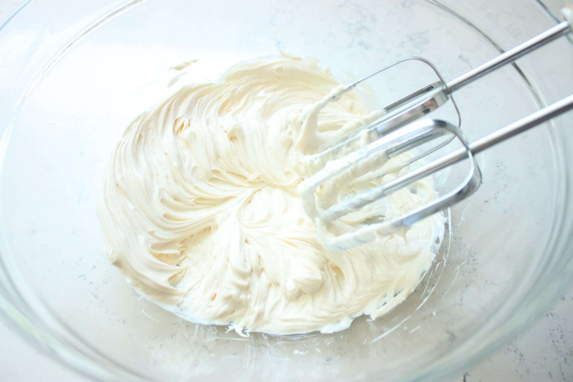 Easy No-Bake Strawberry Cheesecake 6 Mixing the Cheesecake Filling in a Glass Bowl