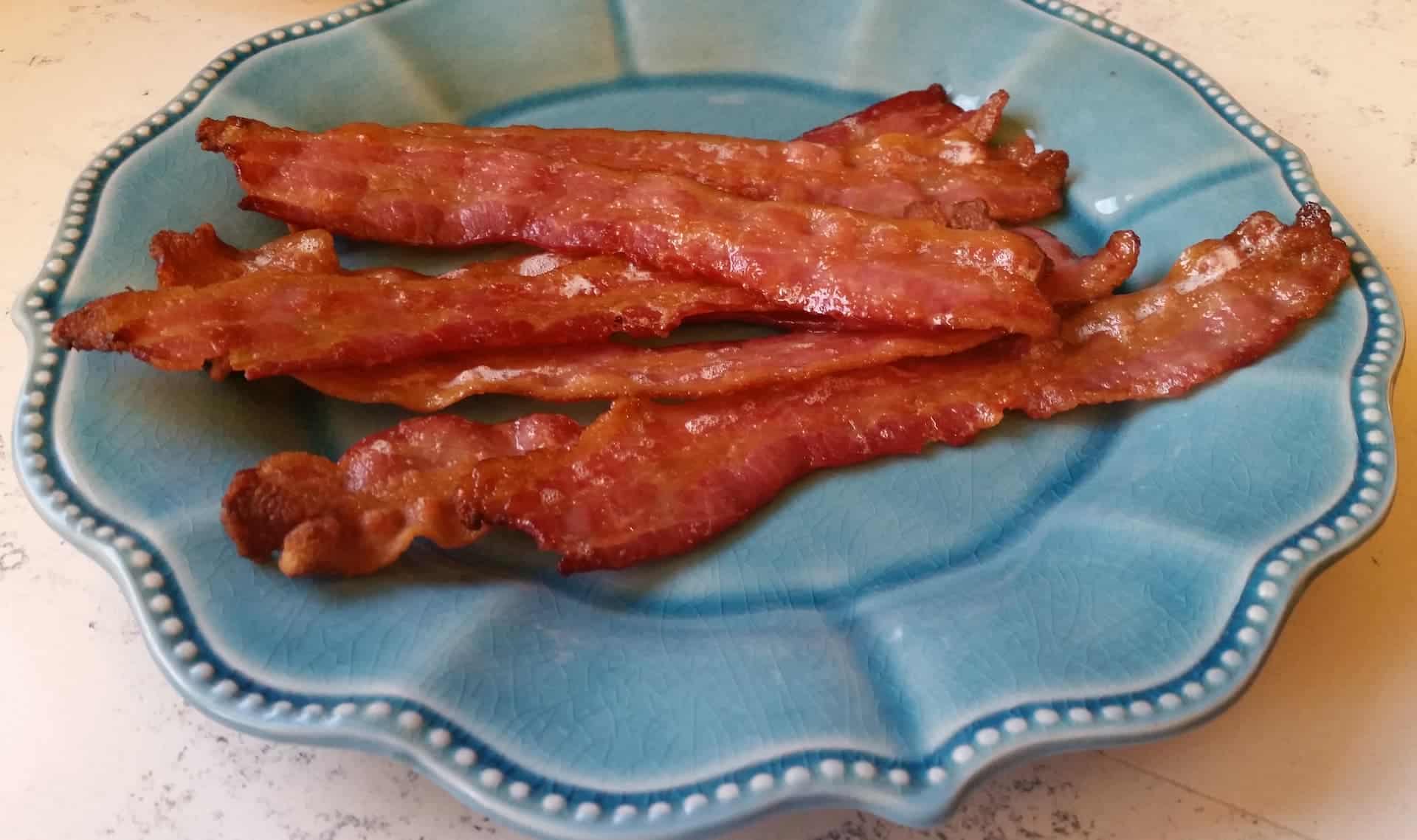 Oven Cooked Bacon on a Blue Plate