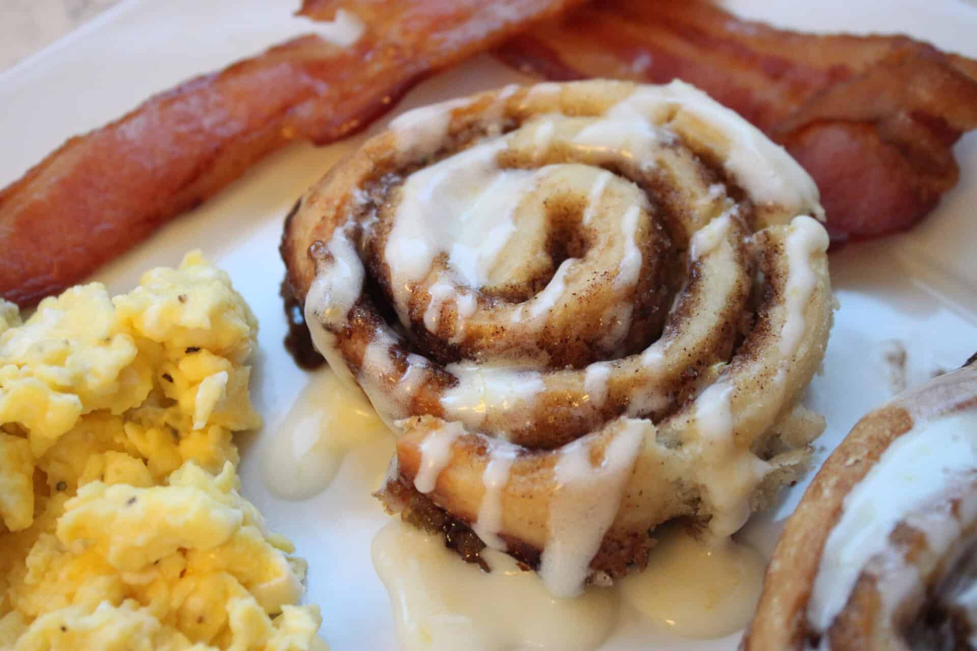 Perfect Homemade Cinnamon Rolls: Say Goodbye to Store-Bought 18 Perfect Homemade Cinnamon Rolls on a Plate with Eggs and Bacon