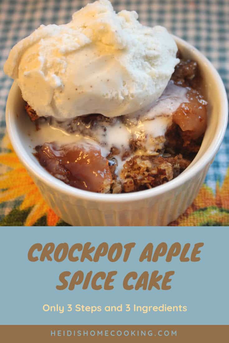 A warm serving of 3 Step Crockpot Apple Spice Cake topped with melting vanilla ice cream in a white bowl on a cozy checked cloth.