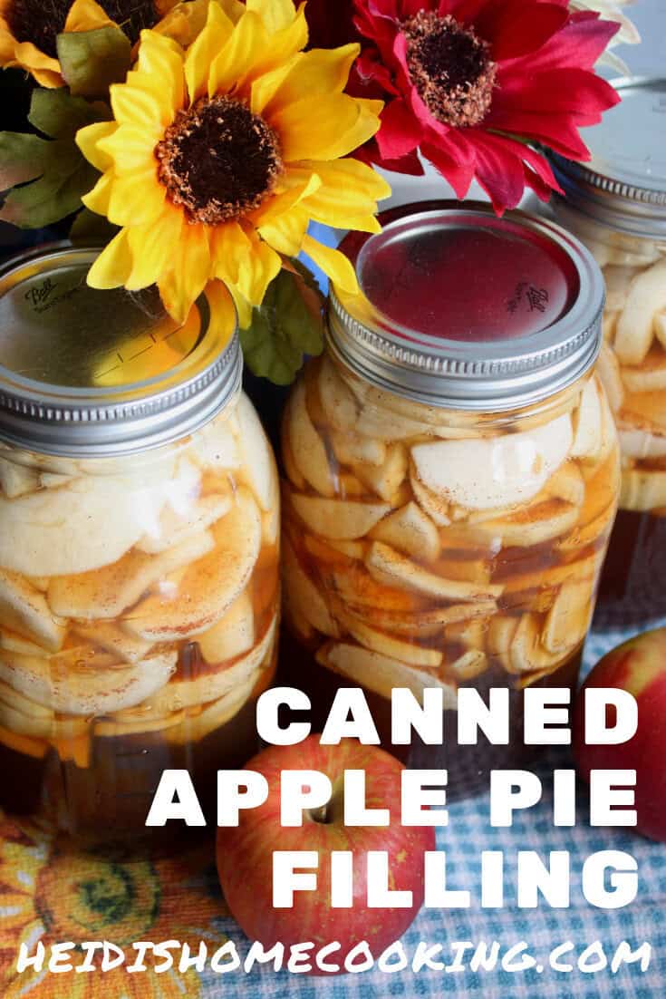 Two jars of Homemade Canned Apple Pie Filling displayed with yellow and red sunflowers, styled for Pinterest pinning and recipe saving.
