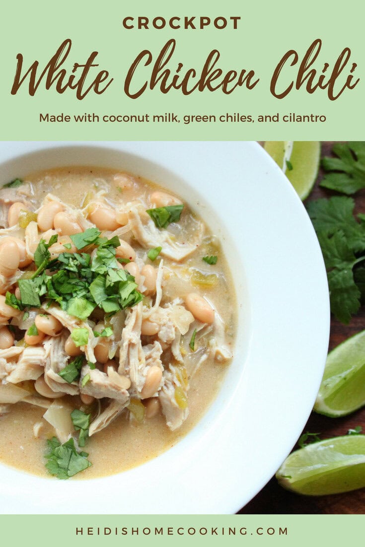 A warm bowl of Healthy Crockpot White Chicken Chili topped with fresh cilantro and served with lime wedges on the side.