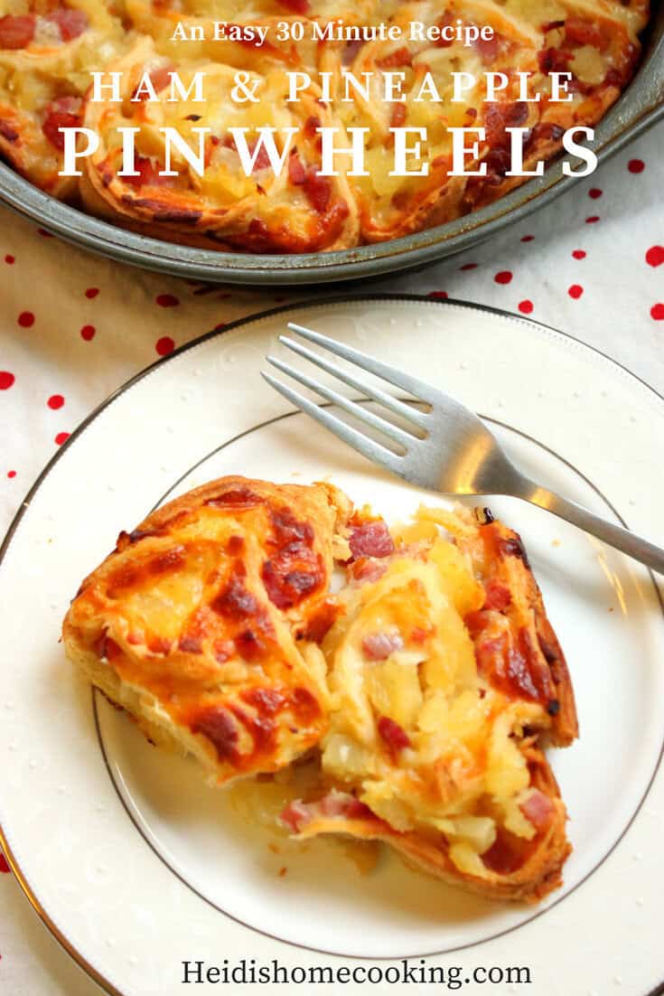 Savory and Sweet Ham and Pineapple Pinwheels for the Family 8 A plate of ham and pineapple pinwheels on a white plate, showing their golden crust, gooey cheese, and vibrant pineapple pieces.