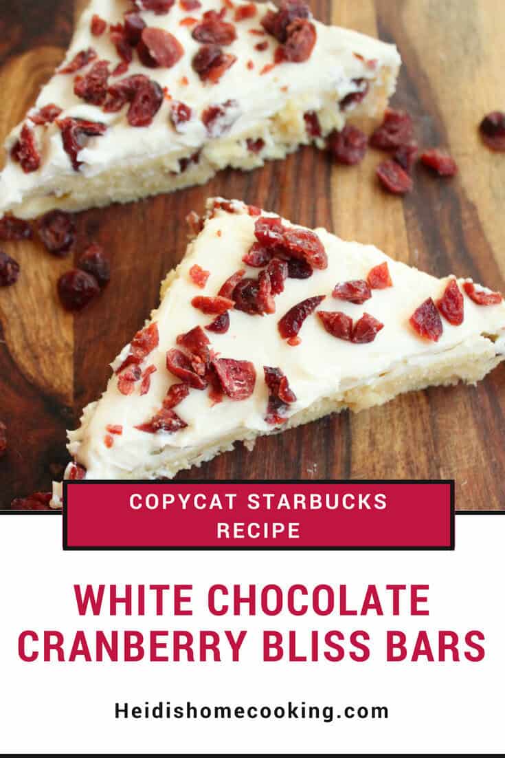 Easy Recipe for Copycat Starbucks White Chocolate Cranberry Bliss Bars 7 A close-up of copycat Starbucks white chocolate cranberry bliss bars topped with cream cheese frosting and dried cranberries.