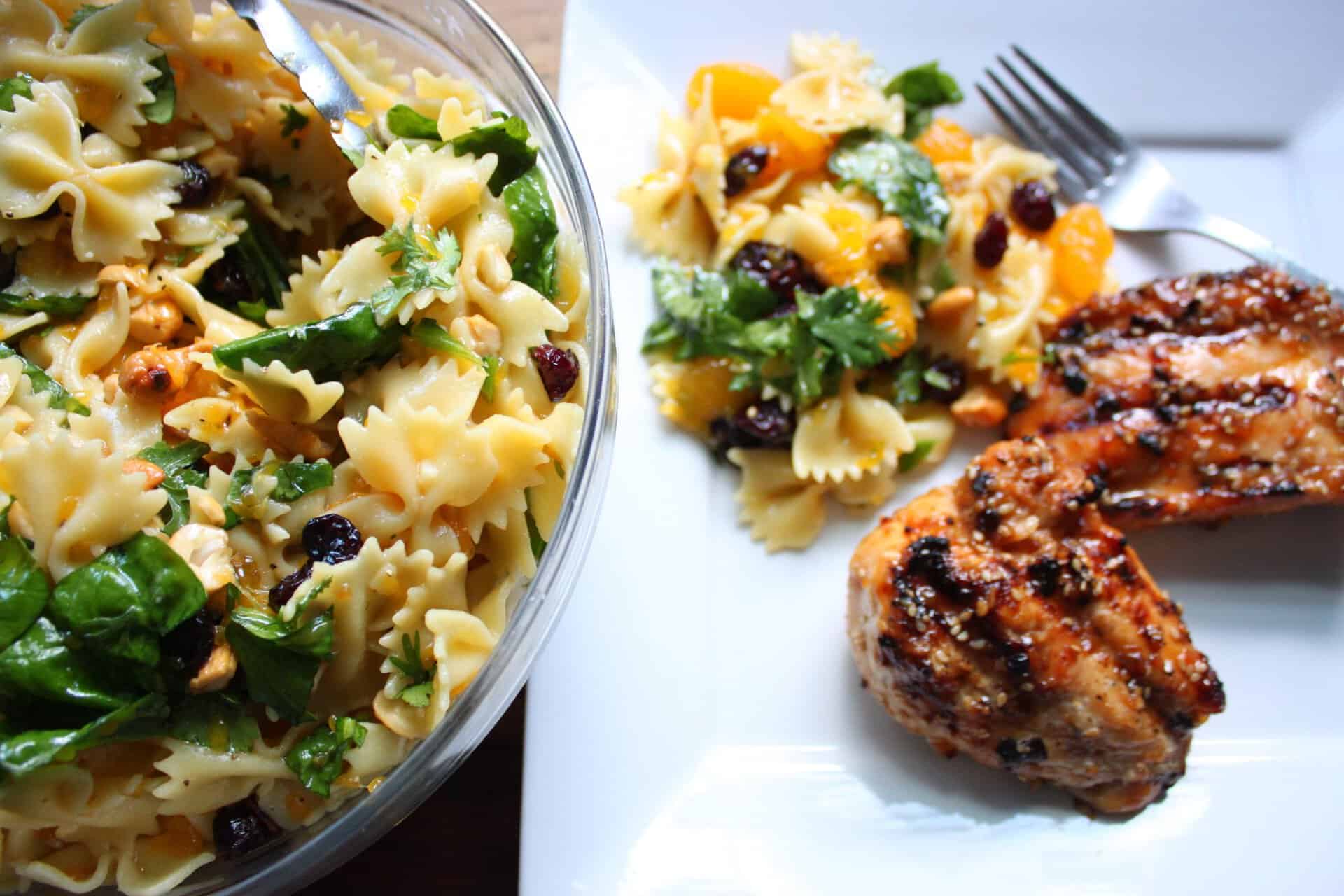 Bowl of Teriyaki Spinach Salad with Mandarin Oranges and a Plate of Grilled Teriyaki Chicken