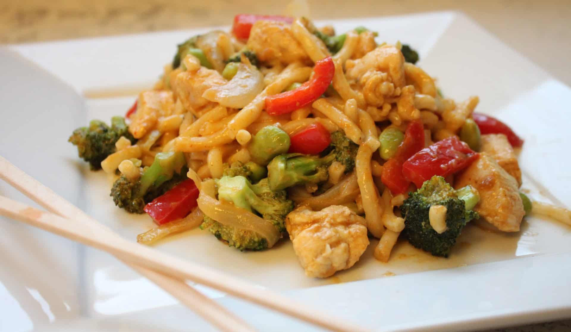 Plate of Thai Chicken Curry with Shelled Edamame on a White Plate