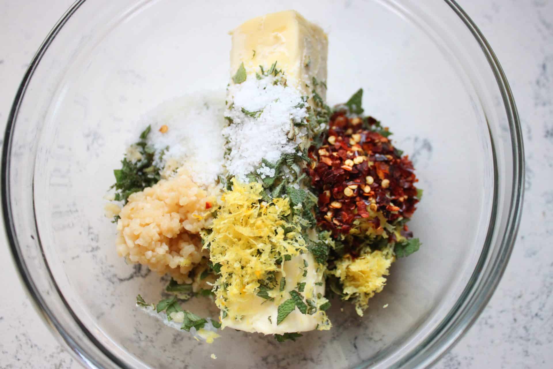 Foolproof 3-Step Tuscan-Style Roasted Turkey for the Holidays 5 Herbed butter mixture with lemon zest, garlic, sage, and spices in a bowl, the secret to juicy Tuscan-style roasted turkey.