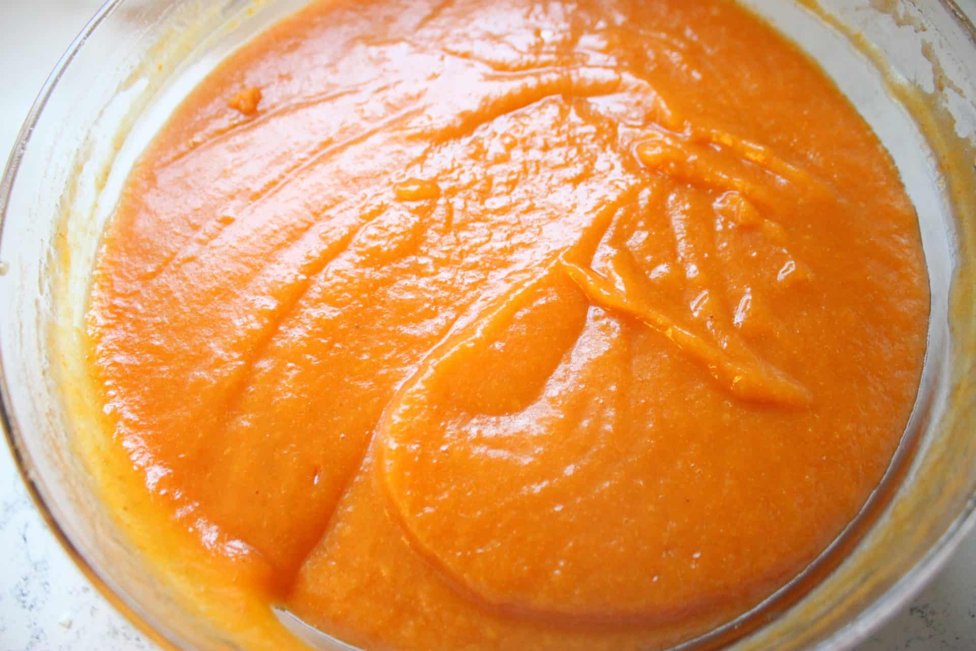 Pumpkin Batter Ingredients Mixed Together in a Large Glass Bowl