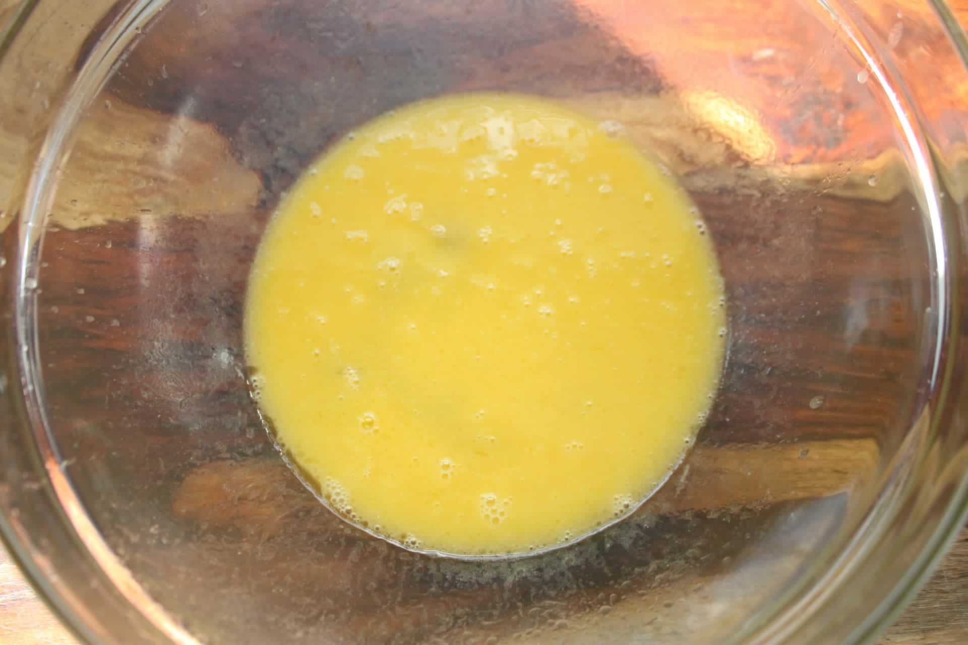 Scrambled Eggs in a Clear Bowl to Make Banana Chocolate Chip Muffins