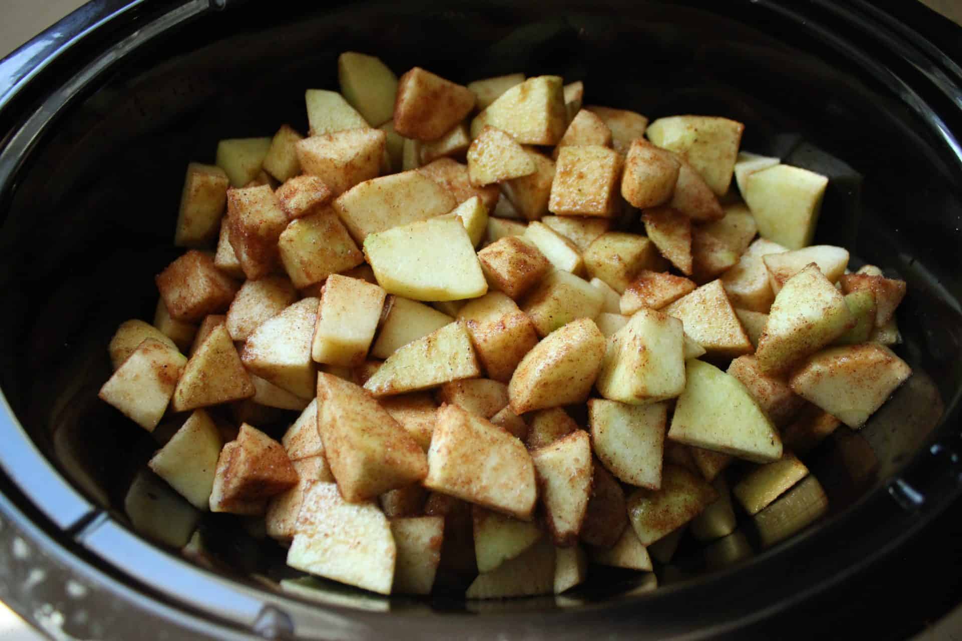 Cozy Up with This Simple Crockpot Cinnamon Applesauce Recipe 5 Cinnamon Seasoned Apples Sitting in Crockpot
