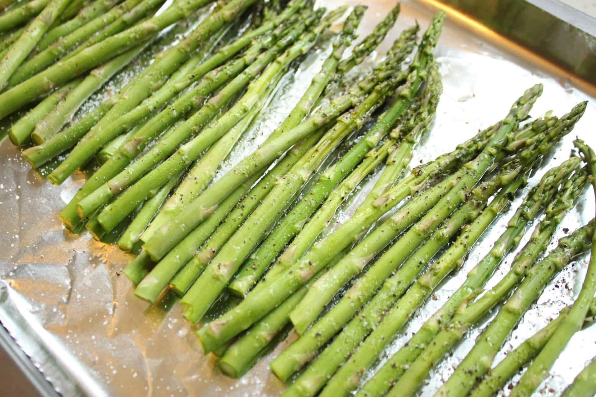 Seasoned Raw Asparagus on a Cookie Sheet
