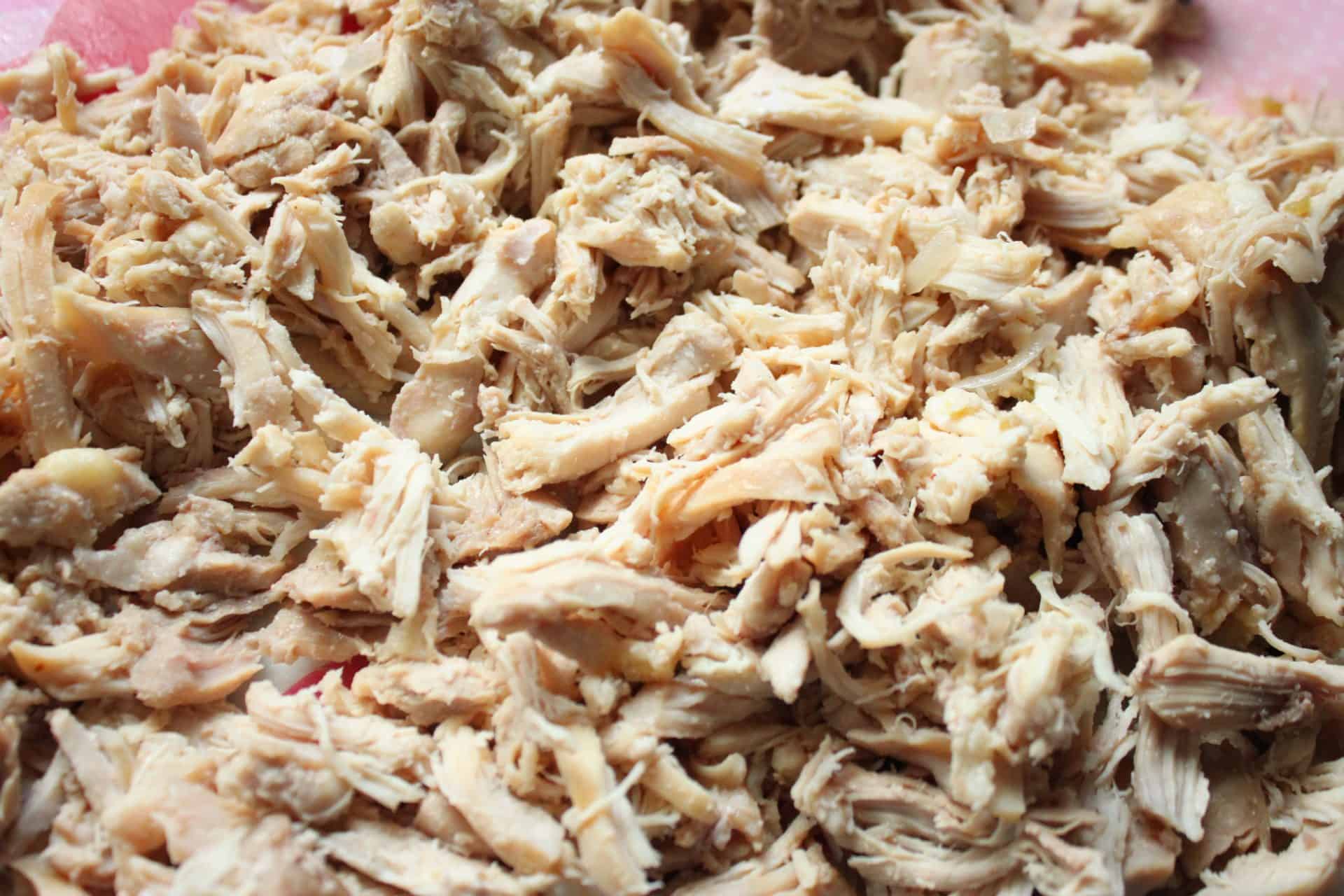 Juicy shredded chicken freshly prepared, ready to be added back into the Healthy Crockpot White Chicken Chili for extra protein.