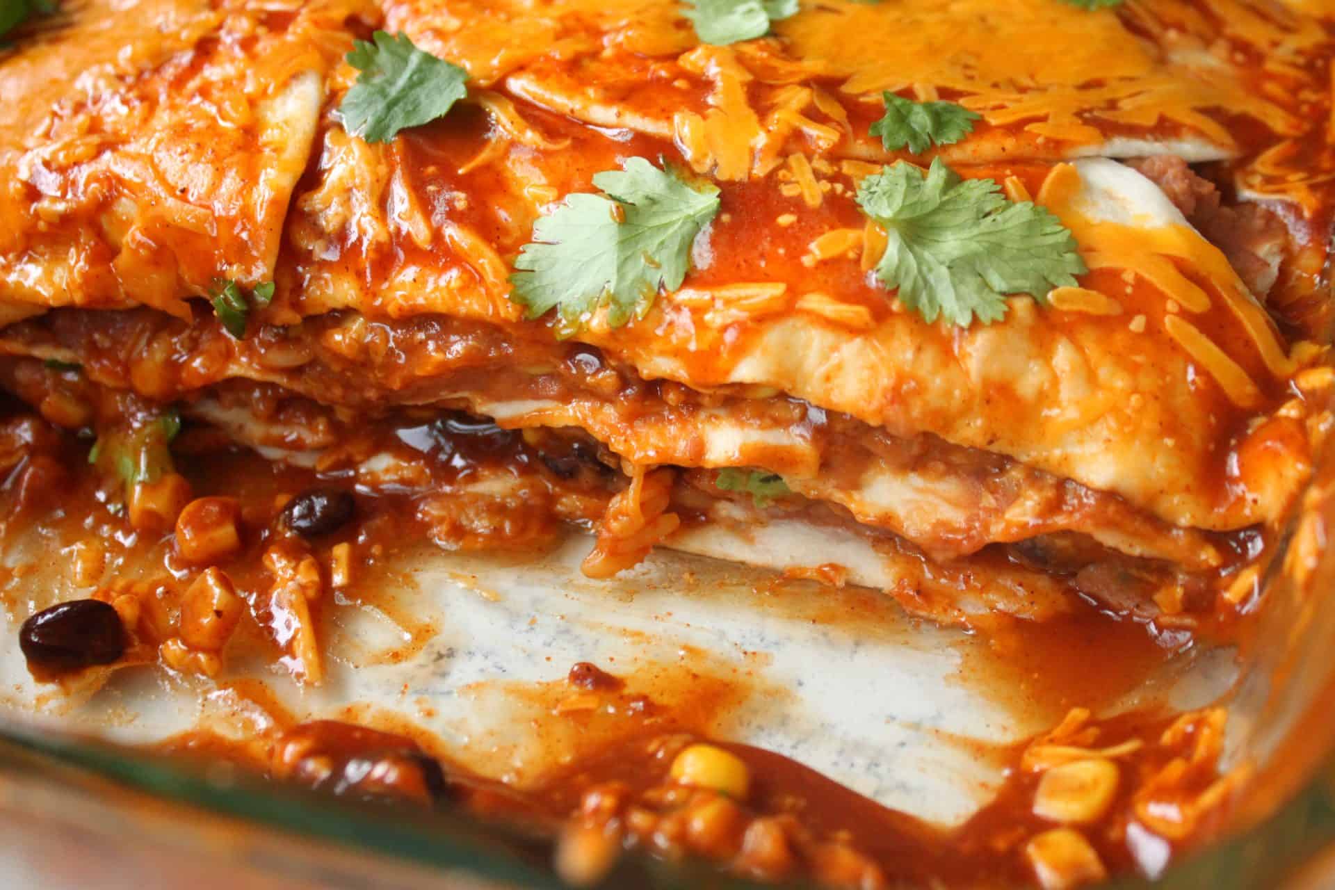 The Budget-Friendly Burrito Lasagna That Feeds 12 for $10 8 Up Close Picture of Slice of Burrito Lasagna