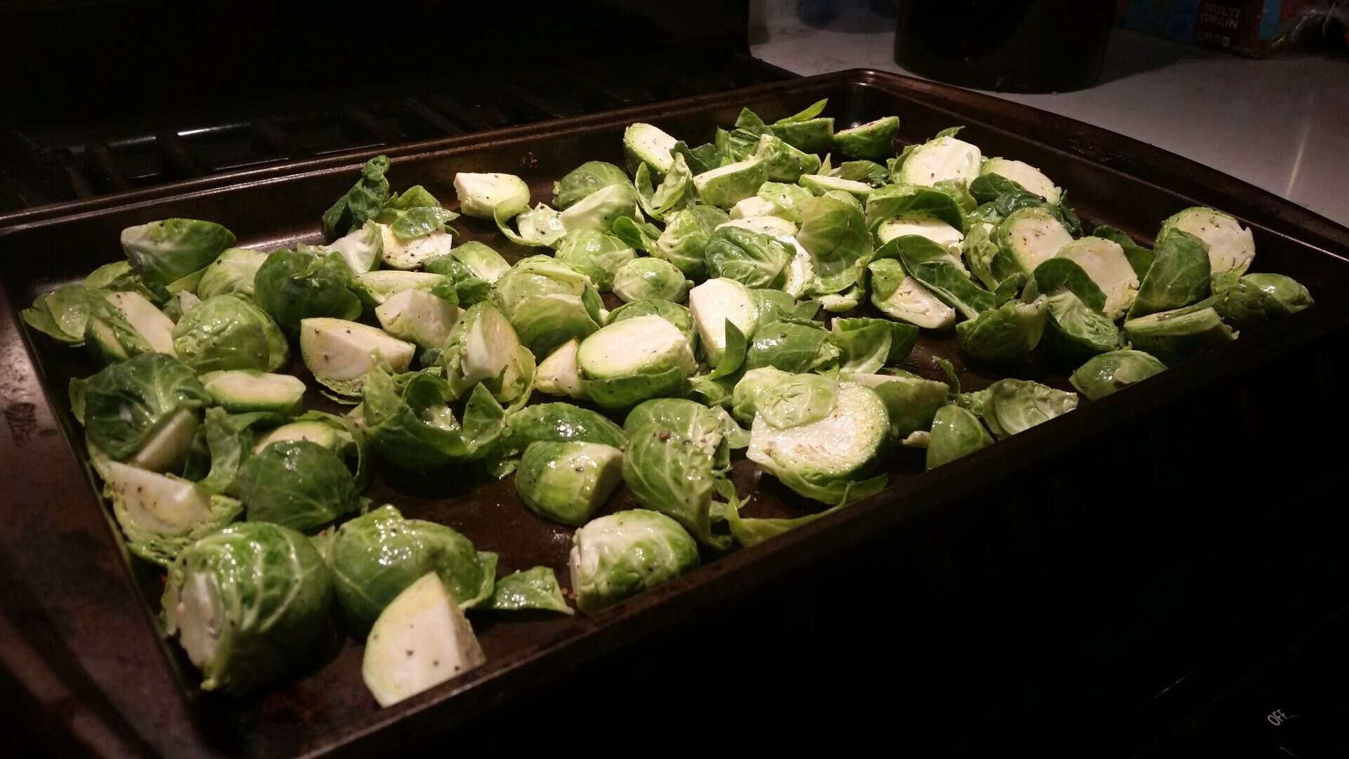 Spreading Chopped Brussel Sprouts on a Large Cookie Sheet