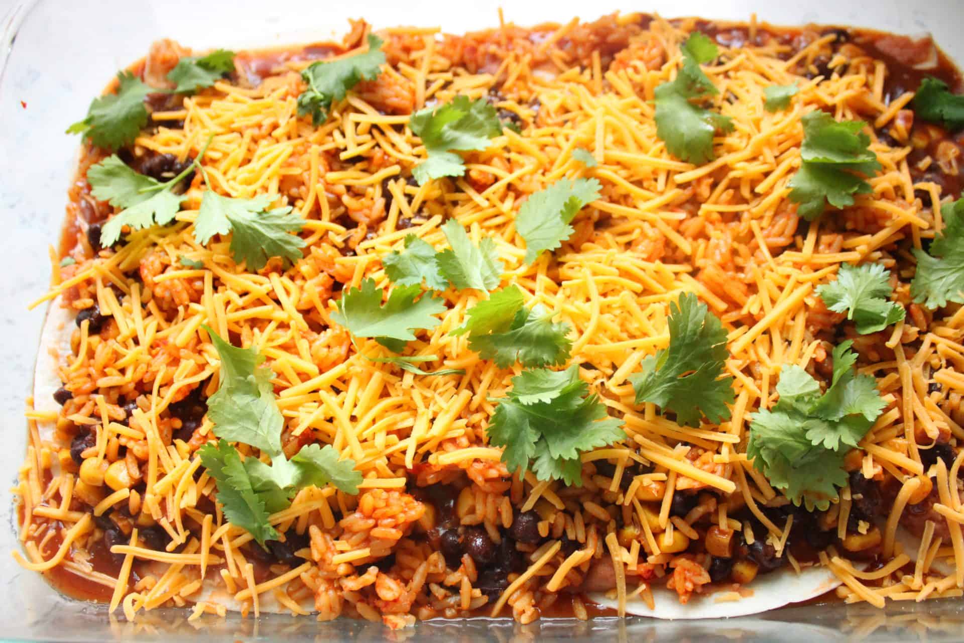 The Budget-Friendly Burrito Lasagna That Feeds 12 for $10 6 Sprinkled Cheese on Top of Burrito Lasagna Garnished with Fresh Cilantro